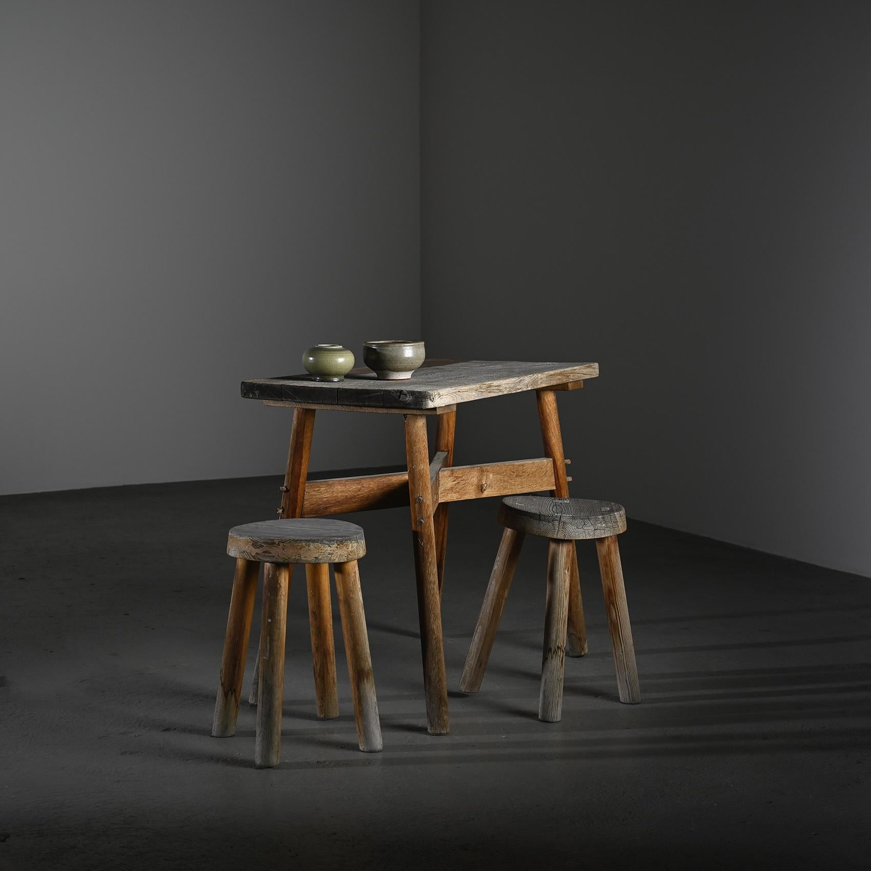 
Rectangular dining table in solid wood, made in the 1950s. Its rustic construction, with pegged joints, recalls the simple forms of mountain furniture or regional cabinetmaking workshops.

The top shows a beautiful, irregular greyed patina, bearing