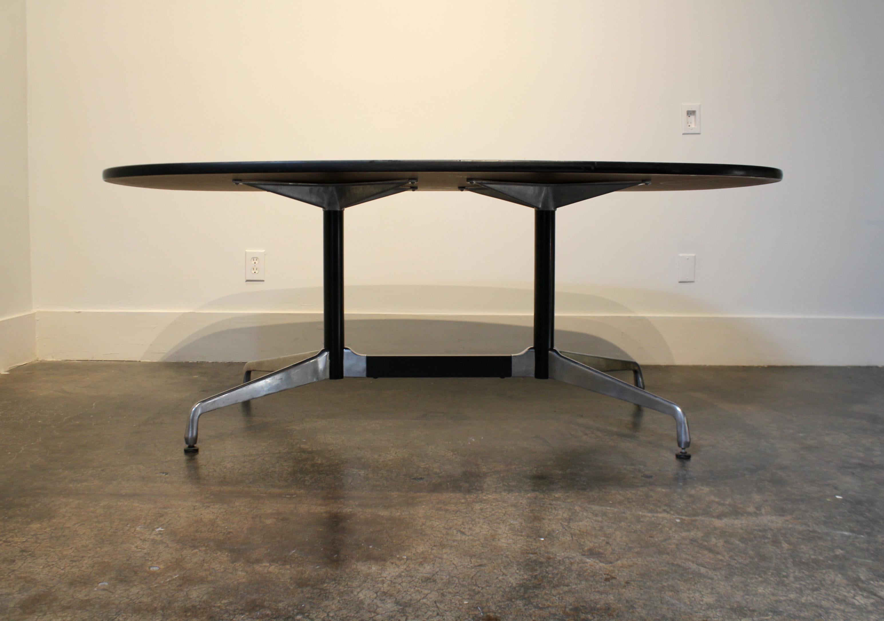 Herman Miller laminates top conference or dining table with a segmented aluminum base designed by Ray and Charles Eames. Classic, minimal midcentury design.

Small scratches to top and legs with a few deeper scratches to top (see pictures).