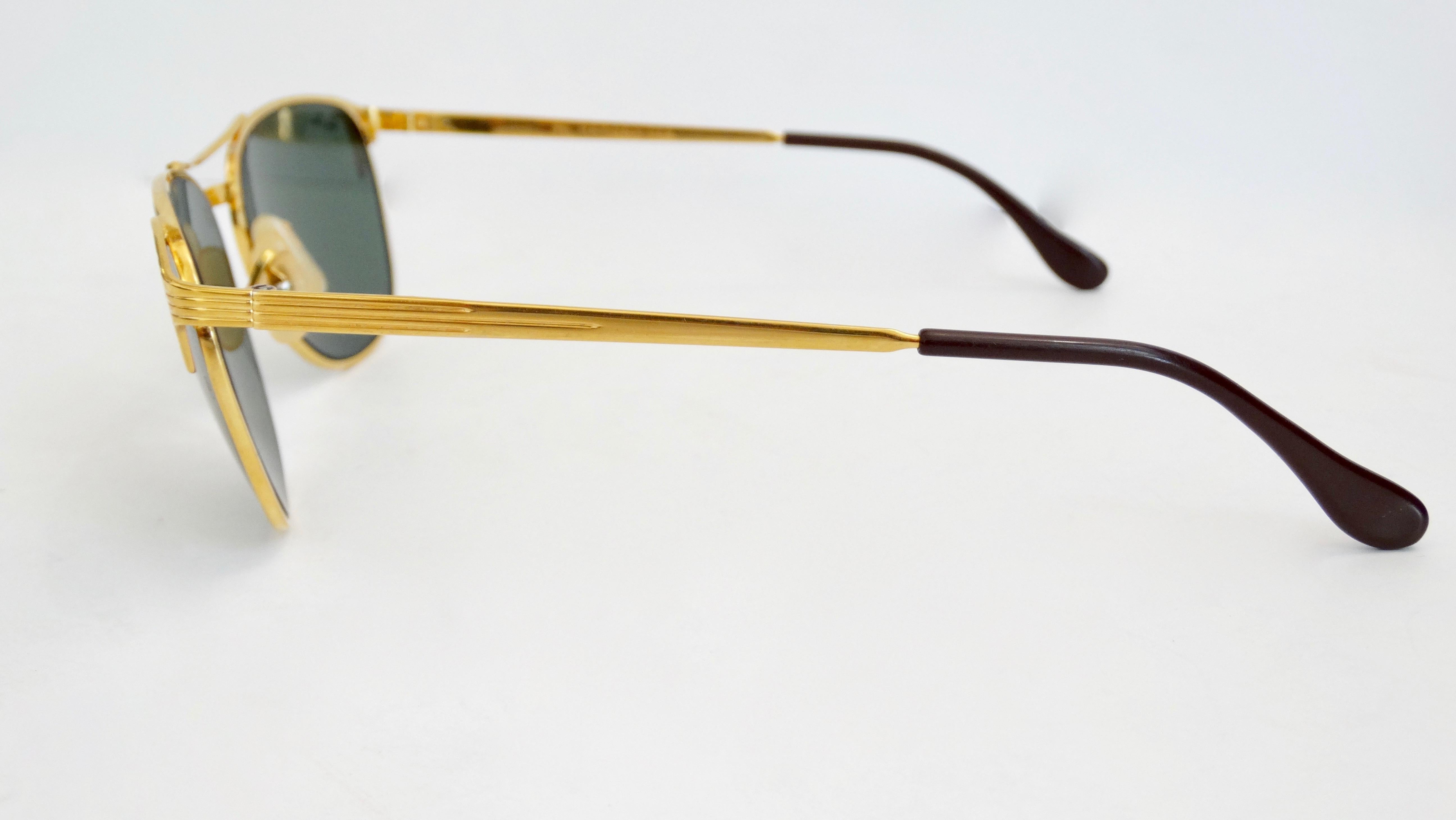 Complete your sunglasses collection with these Ray-Ban and B&L Signet sunglasses! Created in 1953,  these are one of Ray-Ban's most recognizable and classic styles with dark green G-15 lenses and a gold plated B&L frame. They feature the trademark