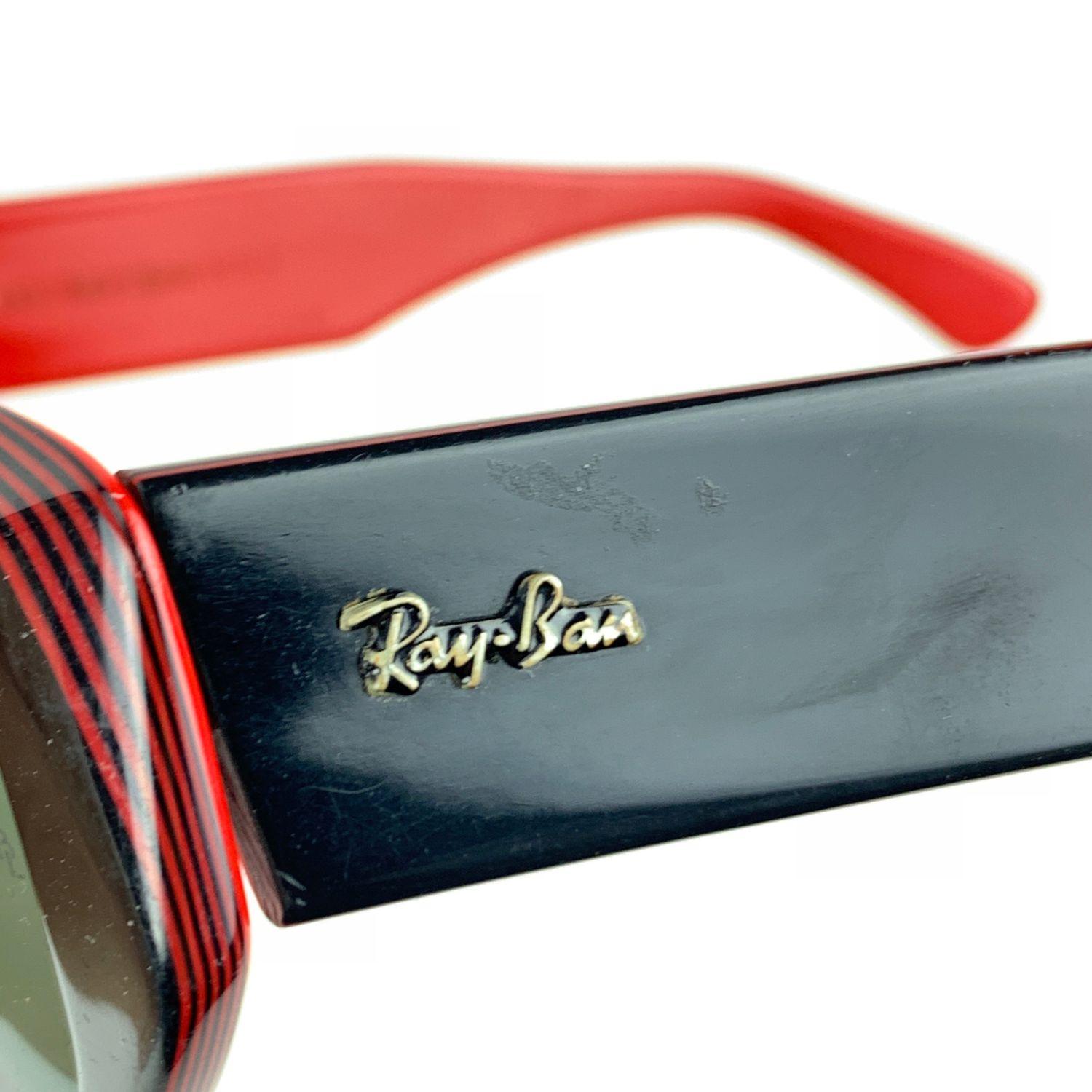 Vintage sunglasses by Ray-Ban Bausch & Lomb, mod. DEKKO. Black and red frame with thick ear stems. Ray-Ban logo on temples. Original 100% UV protection G-15 green lenses. BL - BAUSCH & LOMB logo etched on both lenses

Details

MATERIAL: