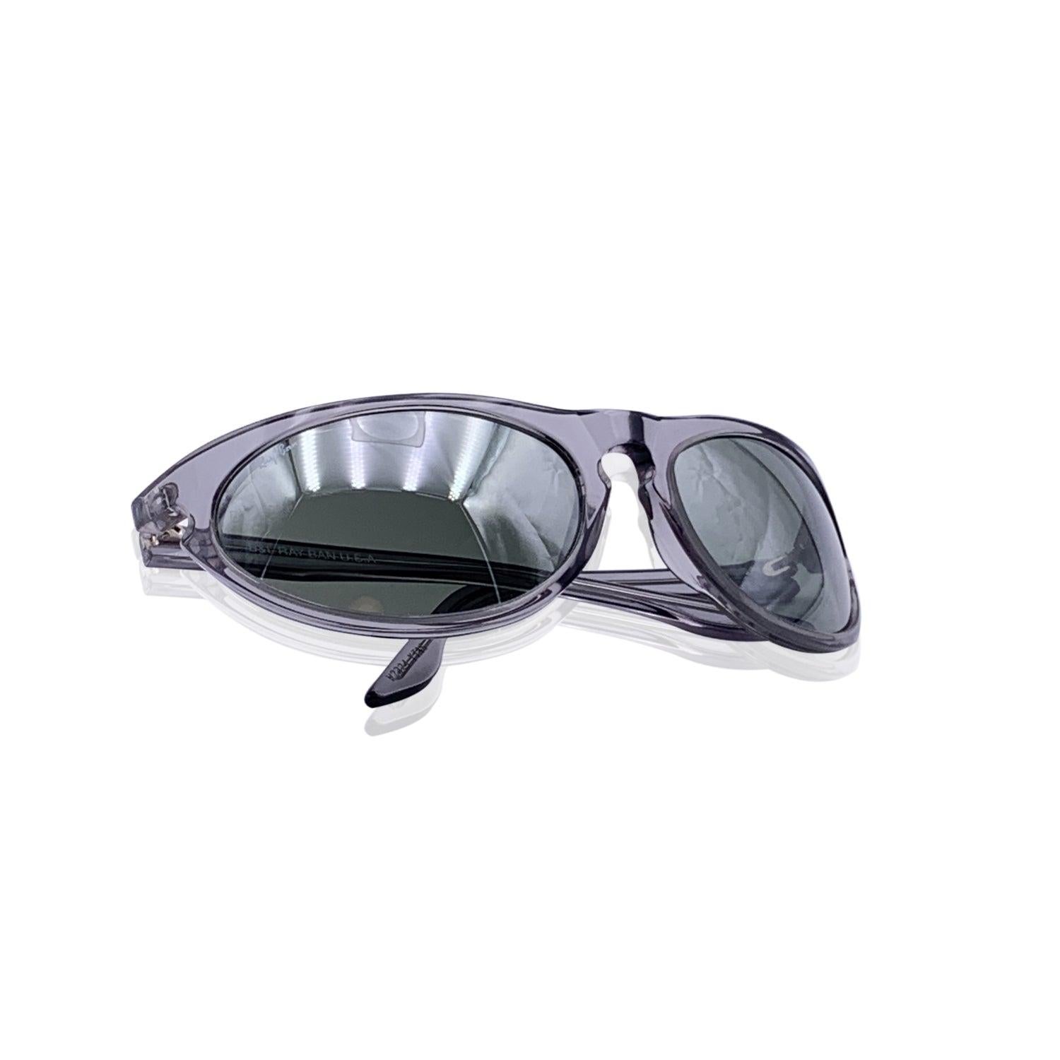 Vintage sunglasses by Ray-Ban Bausch & Lomb, mod. W 2324 Sidestreet. Clear grey acetate frame . Wrap design. Mirrored Grey original lens, with BL etched on both corners. Made in USA Details MATERIAL: Acetate COLOR: Grey MODEL: W2324 Sidestreet
