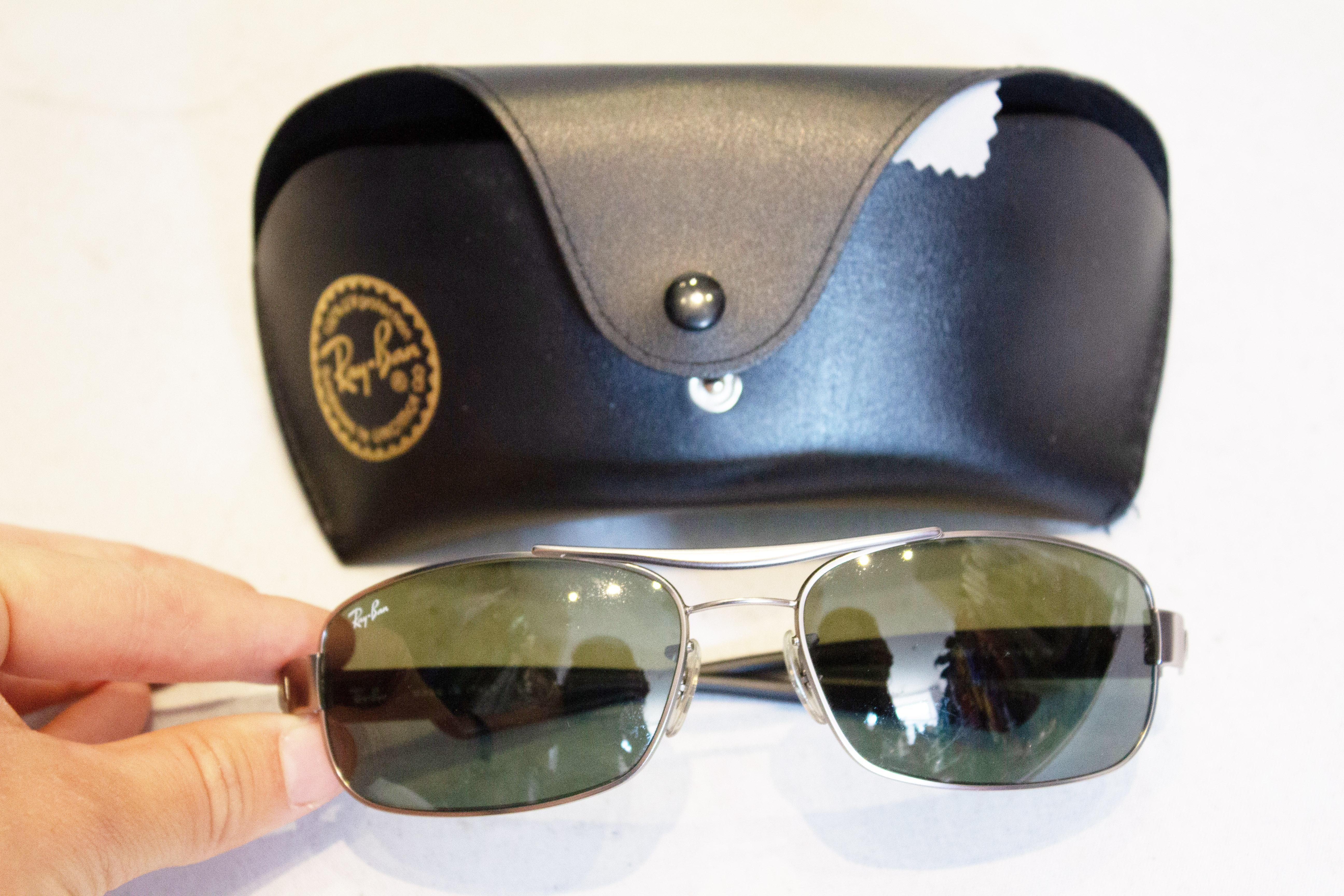 A chic pair of vintage Ray Ban Sunglasses.  They are model number RB3302 005 61/183 N.
Lens height 1 3/4''.