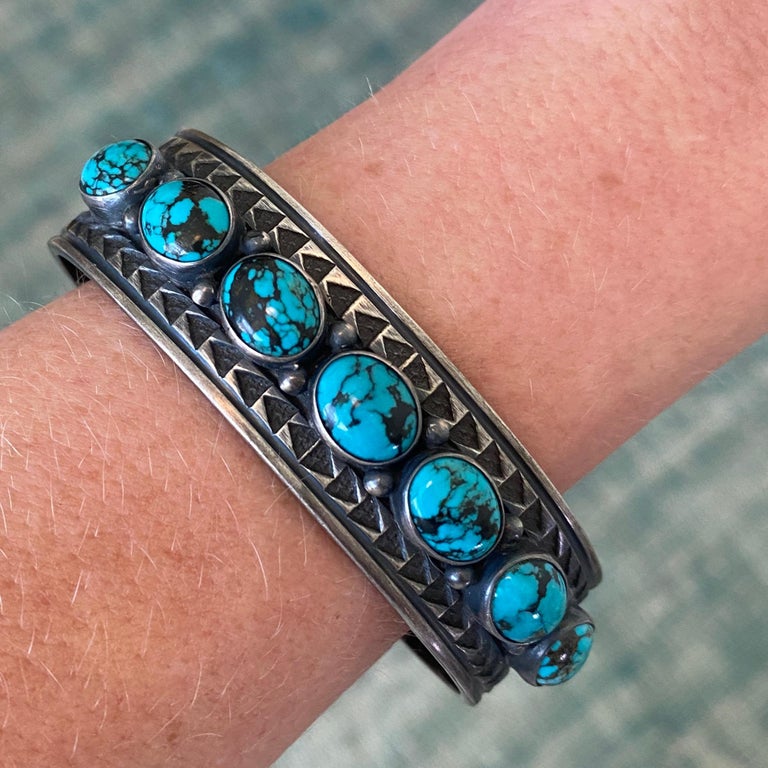 Ray Bennett Spider Web Vintage Navajo Sterling Silver and 5 Turquoise Stone Heavy Cuff Bracelet 
This well made sterling and turquoise cuff was made by Navajo artisan Ray Bennett. It's in good vintage condition with light wear. The turquoise is in