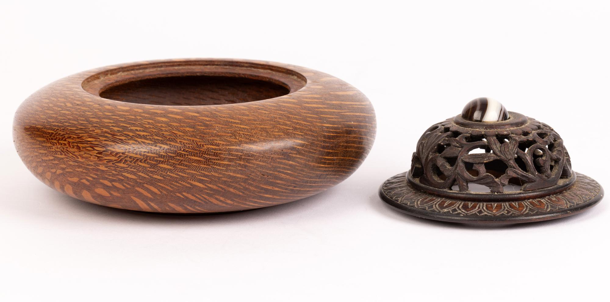 A finely hand-turned Scottish hard wood lidded pot pourri bowl the lid mounted with a polished agate by Ray Brown and probably dating from the late 20th century. The bowl is of round shallow shape with the body made in a wood with a wonderful