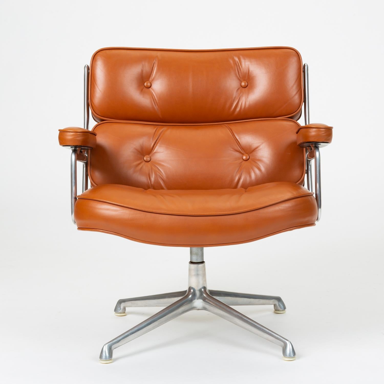A legendary office design by Ray and Charles Eames for the three modernist lobbies of the new Time Life Building in Manhattan, the Time Life lobby chair has a polished aluminum frame and segmented, tufted cushions in leather upholstery. Leather