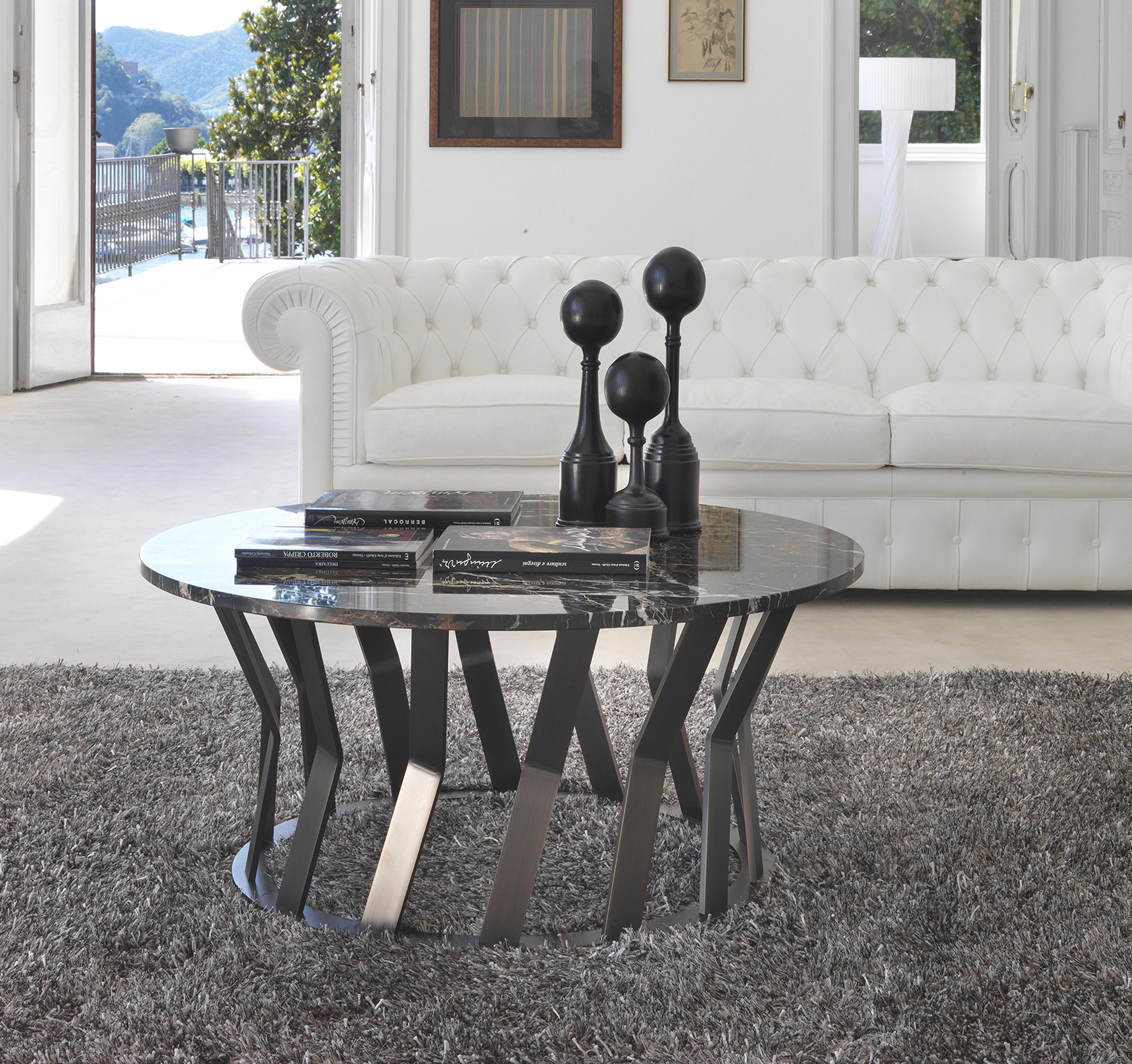 Modern ray coffee table characterized by the articulated structure of the metal base bronze finish that takes inspiration from the most innovative architectural buildings, in support of the round top in black & gold marble (special).
Measures:
