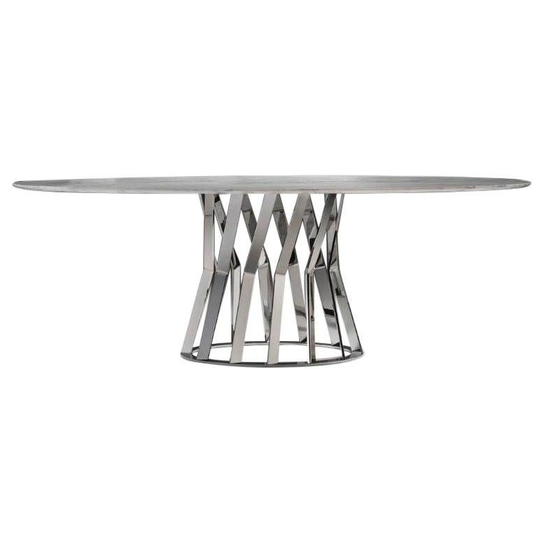 Modern ray dining table characterized by the articulated structure of the metal base chrome finish that takes inspiration from the most innovative architectural buildings, in support of the oval top in Calacatta Oro marble.
Measures: cm 220 x