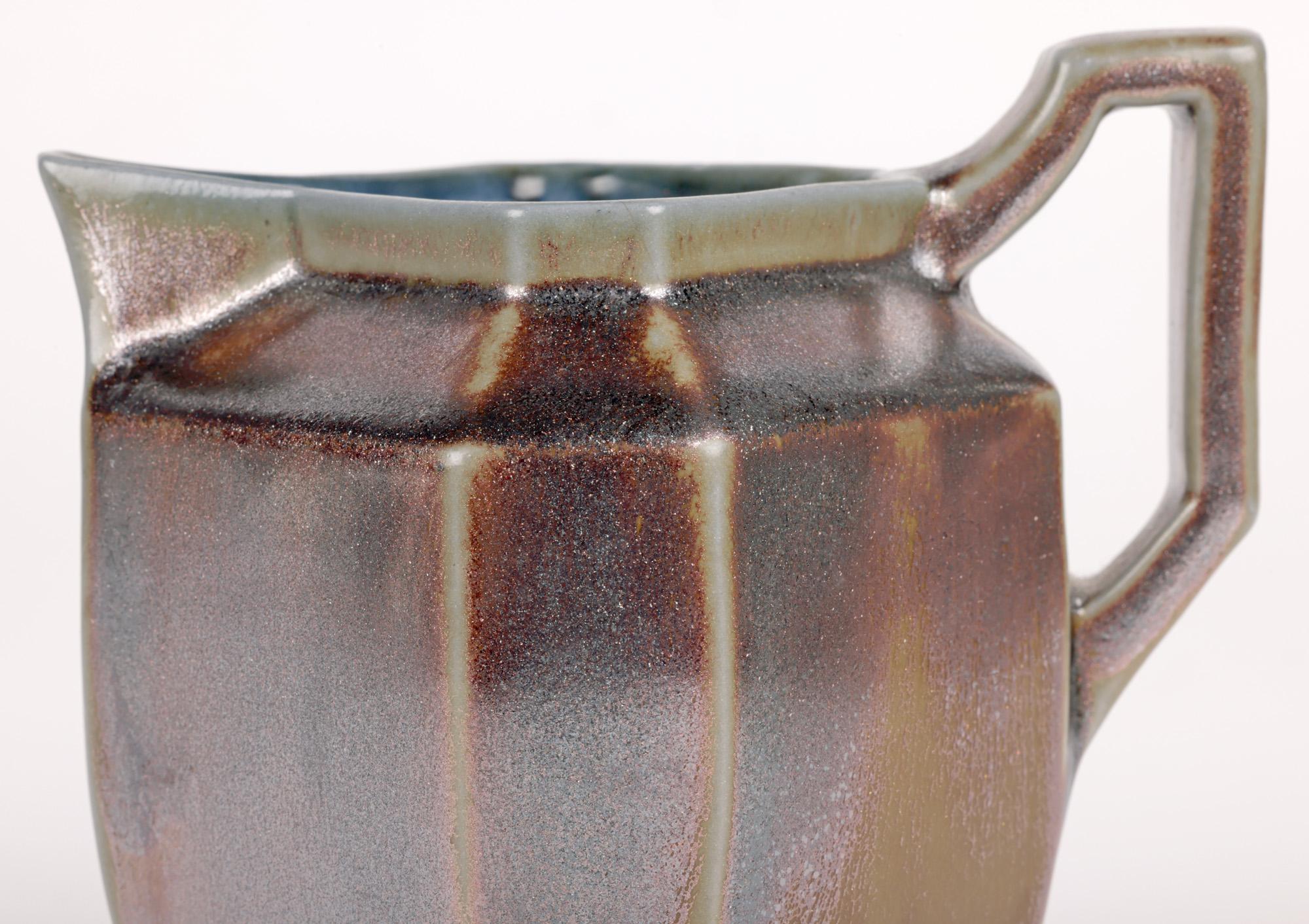 An unusual and exceptional metallic glazed studio pottery jug by Ray Finch and made at Winchcombe around 1981. The stoneware jug was gifted by Ray Finch to the previous owner on 5th August 1981 and was described as a ‘double cream’ jug and is a