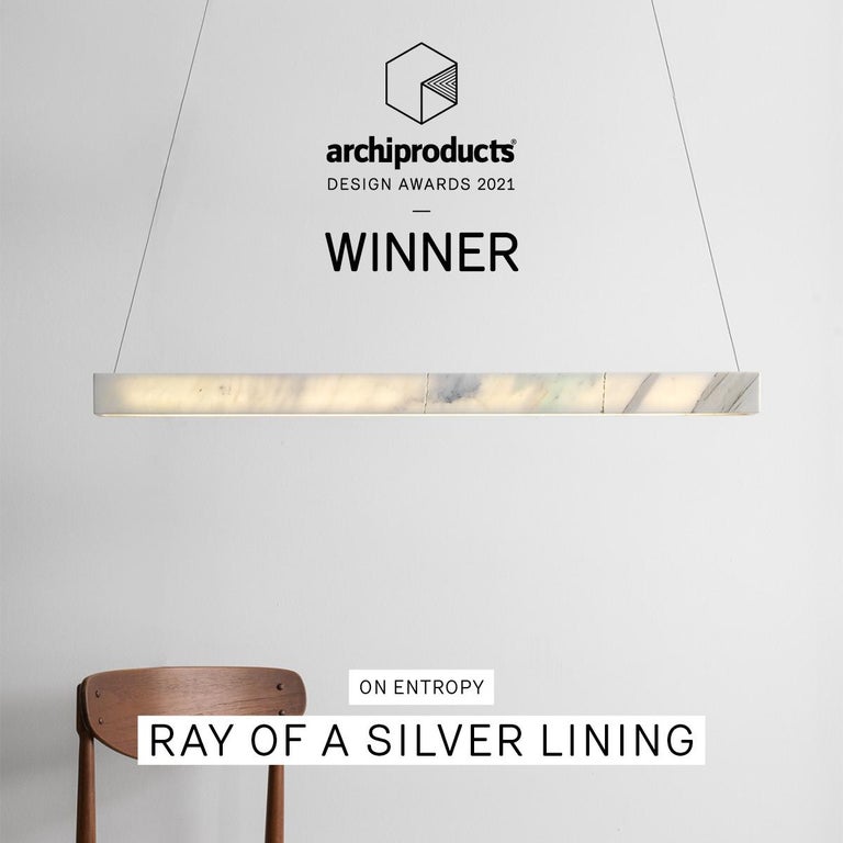 Ray pendant light highlights the translucency of marble and its unique crystalline quality. 

It consists of a seamless volume of marble with no cables other than suspension wires. Where marble is carved, light is introduced which exposes the