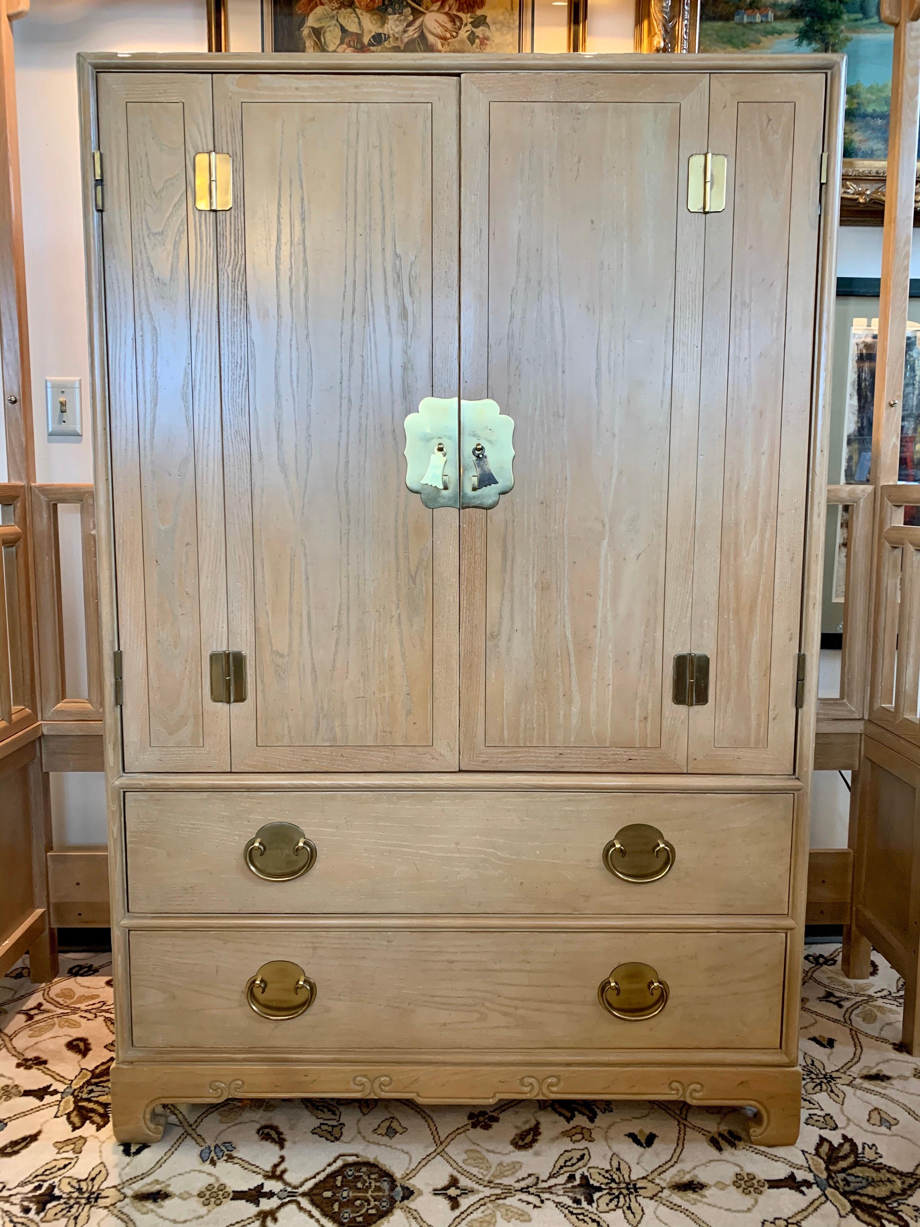 An elegant mens wardrobe dresser cabinet by Ray Sabota for Century Furniture Company in cerused oak, circa 1970s. Brass hardware and lovely motifs accent the piece. Functional scale will allow for use in many different rooms; think bedroom, living