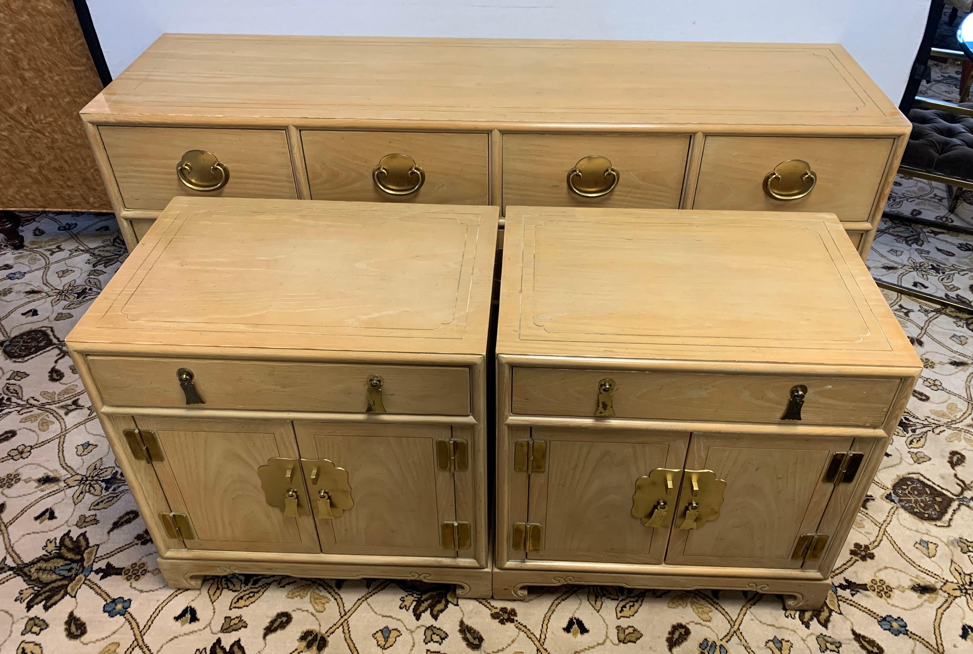A gorgeous three piece matching set with a chest of drawers and two matching nightstands by Ray Sabota for Century Furniture Company, circa 1970s. Brass hardware and lovely motifs accent the pieces. Excellent vintage condition. Retains the maker