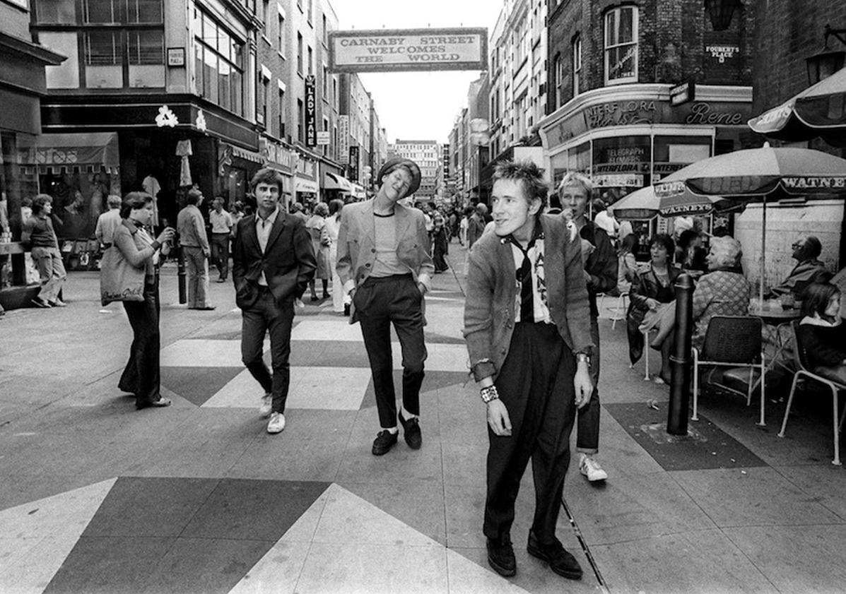 Signed limited edition fine art photograph of The Sex Pistols by Ray Stevenson.

Shot on London's famous Carnaby Street, this pre-Sid Vicious, early shot of the Pistols features original bass player Glen Matlock.

Signed limited edition print #44/100