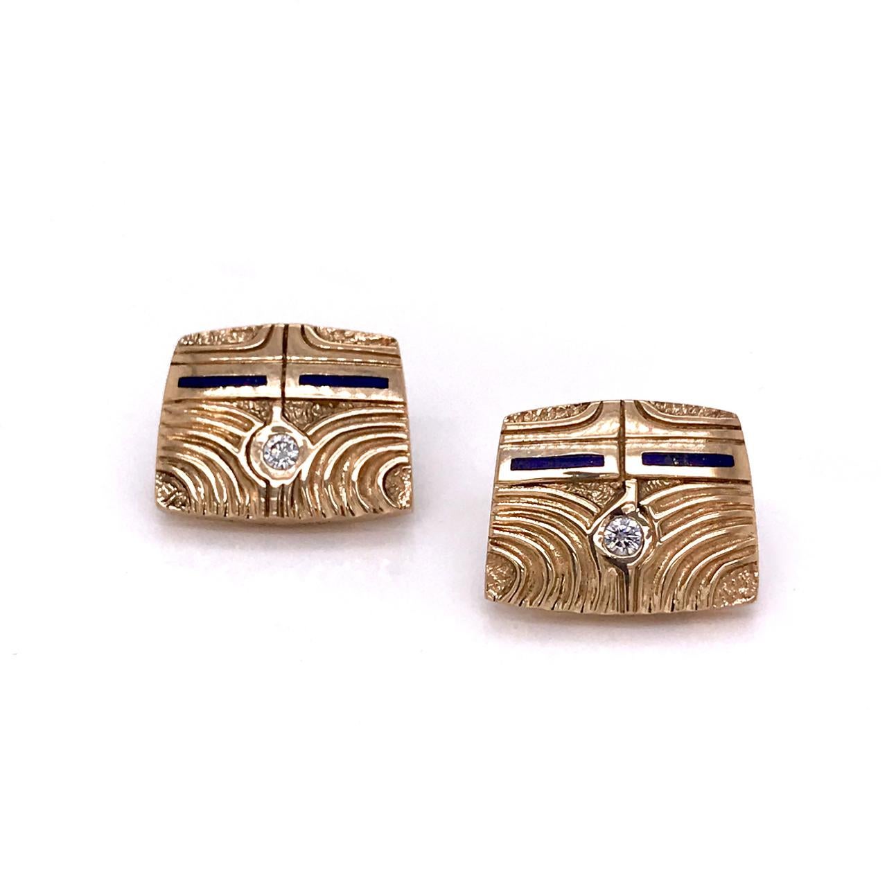 A wonderful pair of 14k gold earrings by Ray Tracey Knifewing.

Each set with a round cut diamond and decorated with enamel and hand wrought decoration to the fronts.

Simply a great pair of earrings from a great Native American jewelry