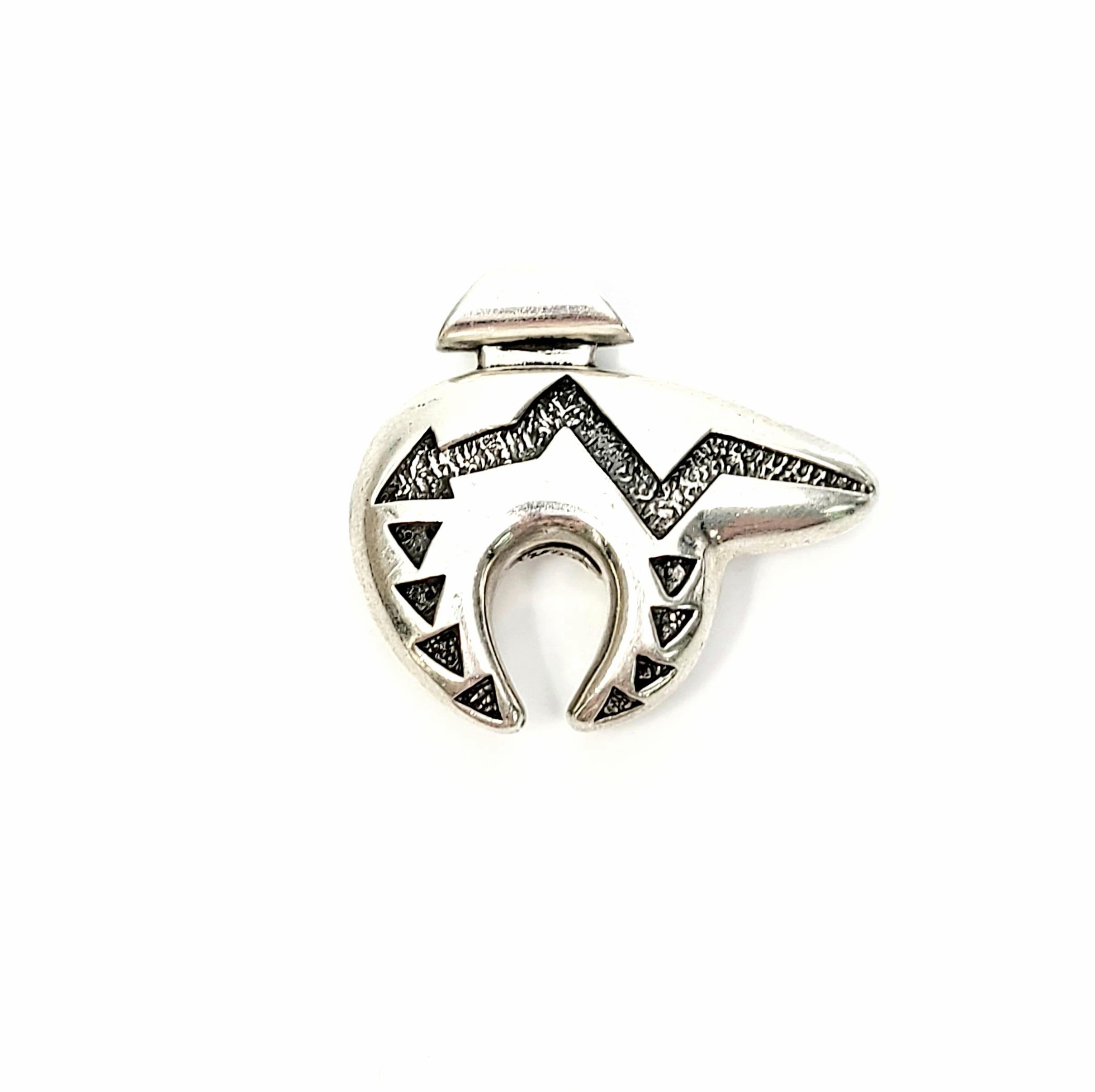 Sterling silver small Heartline bear pendant by Native American Navajo artisan, Ray Tracey.

The bear symbolizes a fierce warrior and great hunter. The heartline runs from the mouth thru the heart. It symbolizes wisdom and a lifeline to the soul. On