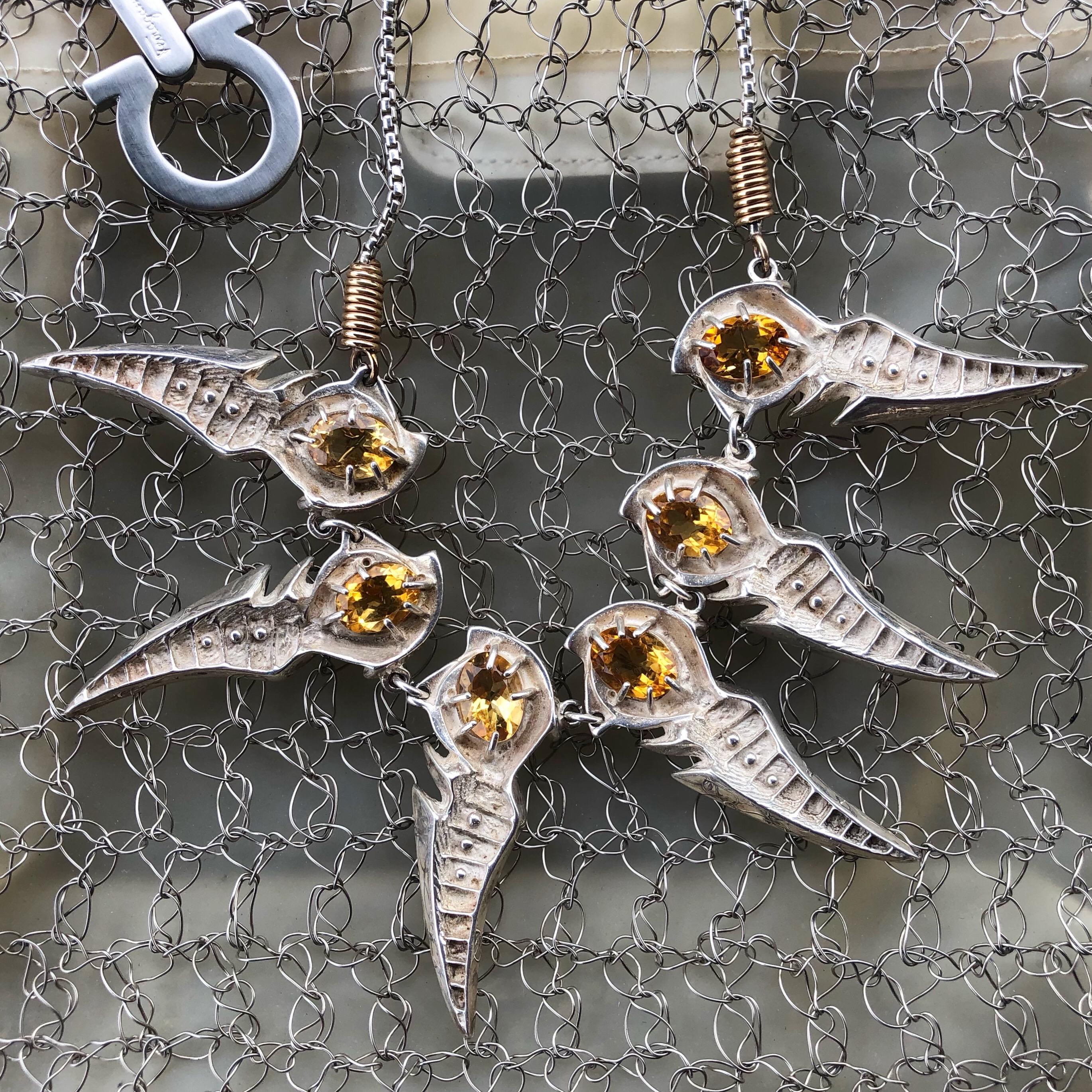 Amazing necklace to add the perfect edge to all your looks! Designed by Ray Wiley, this industrial style Silver/Brass necklace features six abstract pendants set with oval Citrine stones. Adjustable length with spring ring accents, 119.4g. The