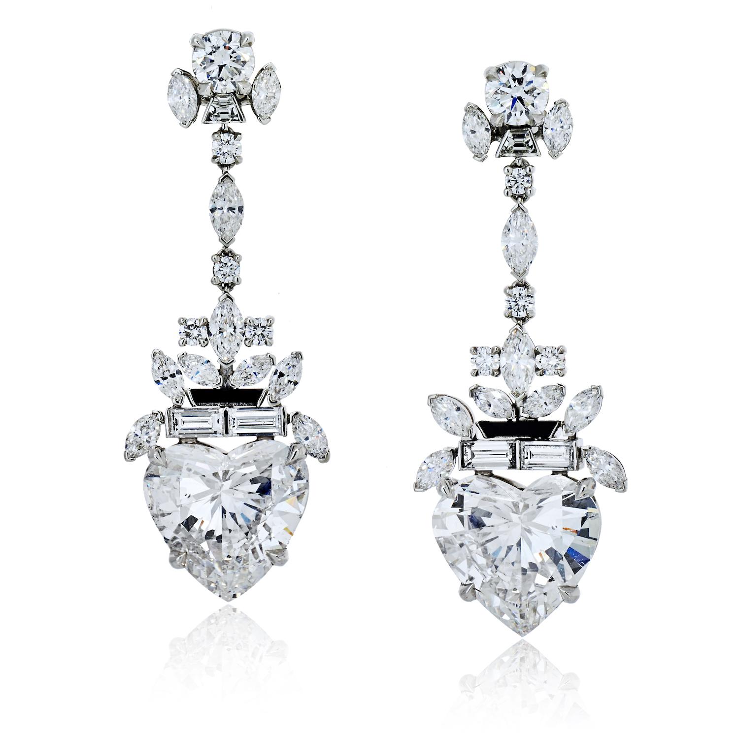 The Raymond Yard diamond drop earrings are an exquisite masterpiece crafted from the finest materials. Made of platinum, the earrings are adorned with a combination of round, baguette, and marquise cut diamonds, each of which adds a unique and