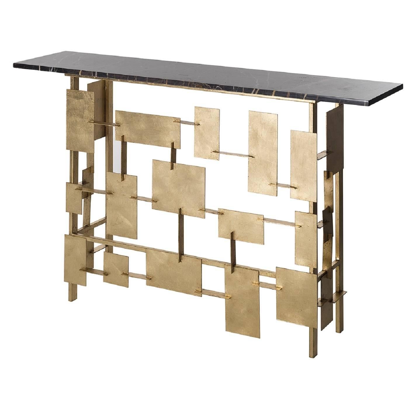 This beautiful console is ideal when placed in a modern environment as it instantly enhances the look of any decor. Part of the Raymond collection, it has an iron structure with abstract elements decorated with metal leaf. The top is in black