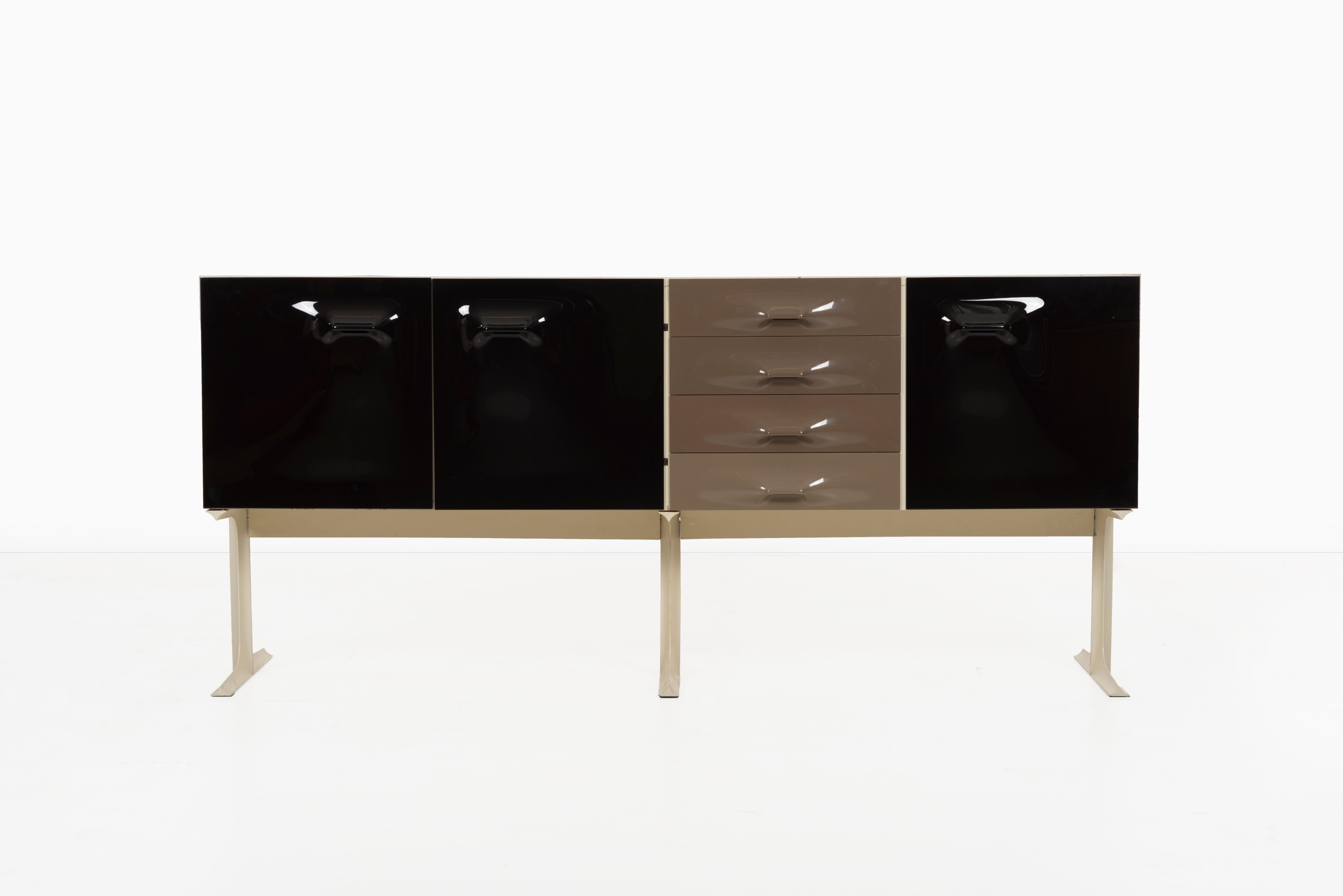 Loewy cabinet features 4 drawers and 3 doors concealing bottle storage, four drawers and two shelves. Paper manufacturer's label to interior ‘DF 2000 Made in France’.