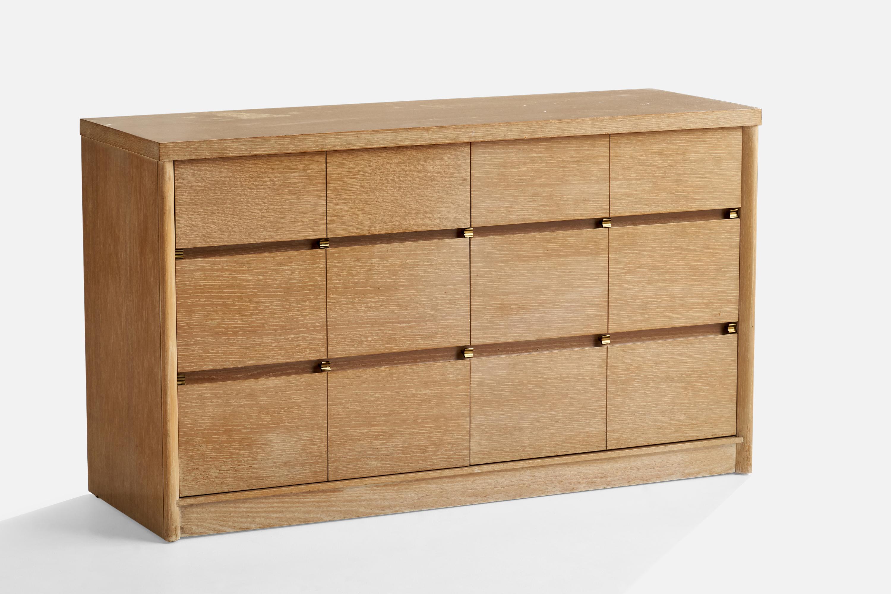 A an oak and brass dresser designed by Raymond Loewy and produced by Mengel Furniture Company, c. 1950s.