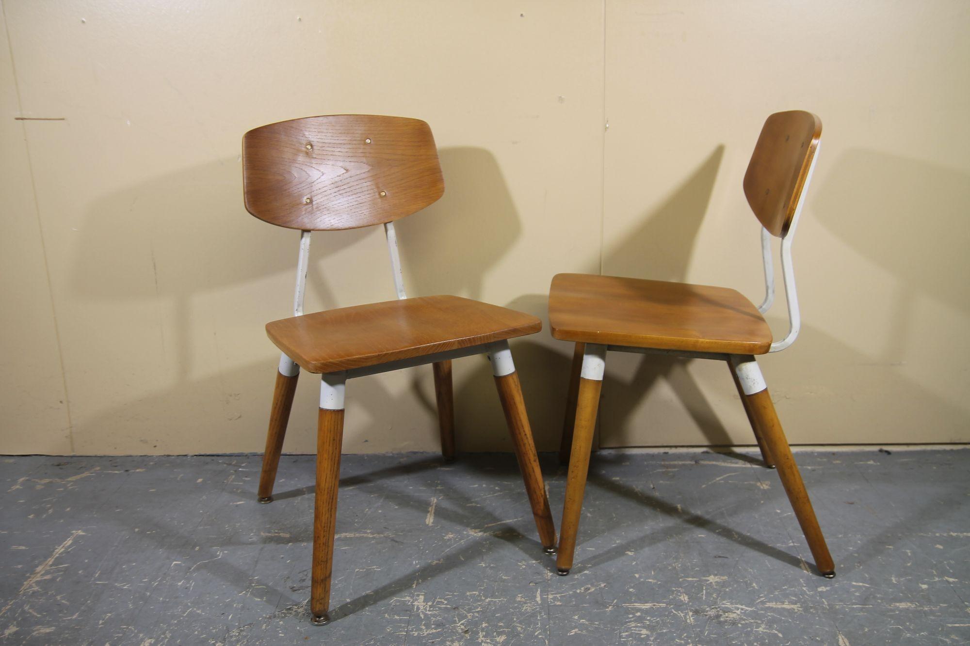 Offering a nice pair of chairs designed by Raymond Loewy for Hill Rom. These 1950's waiting room chairs are made with walnut and steel painted white. A great pair of chairs to go around your small table. These are in nice vintage shape