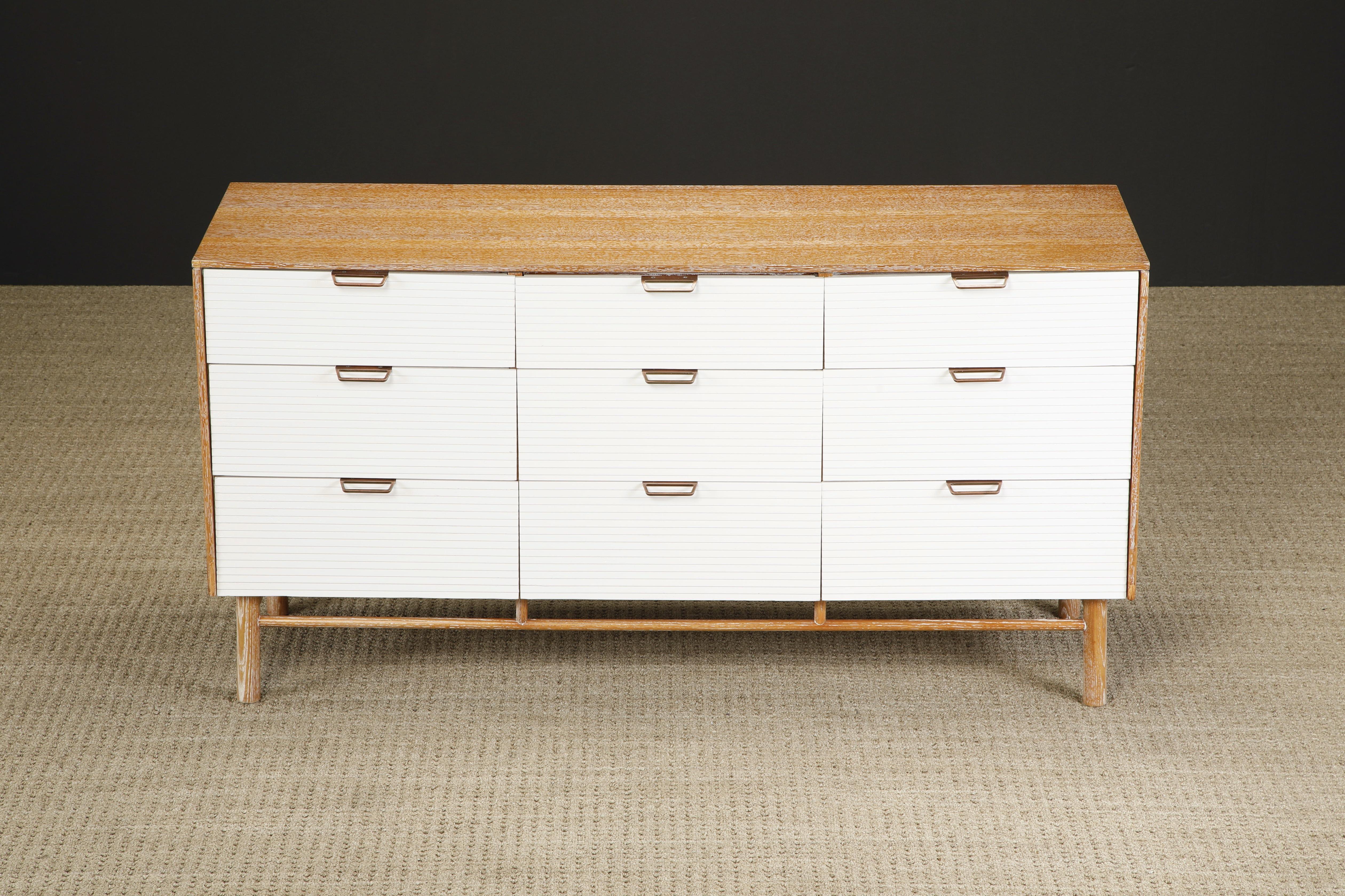 A desirable, rare and restored 9-drawer dresser by Raymond Loewy for Mengel, circa 1955, comprised of rift-sawn cerused oak with white lacquered drawer fronts and brass pulls. This Mid-Century Modern collectors piece is ready for immediate use.