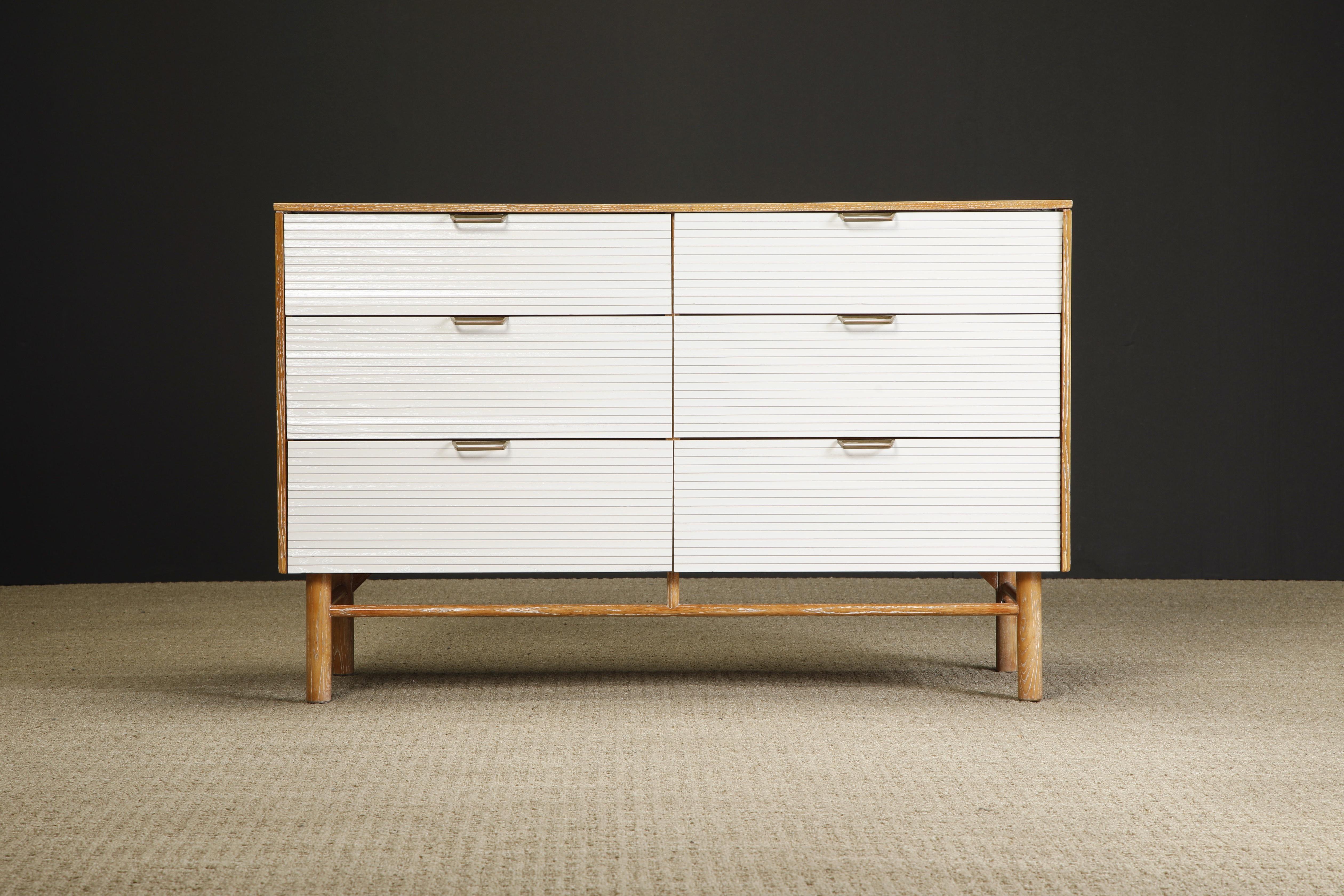 A desirable, rare and restored 6-drawer dresser by Raymond Loewy for Mengel, circa 1955, comprised of rift-sawn cerused oak with white lacquered drawer fronts and brass pulls. Signed in one drawer. This Mid-Century Modern collectors piece is ready