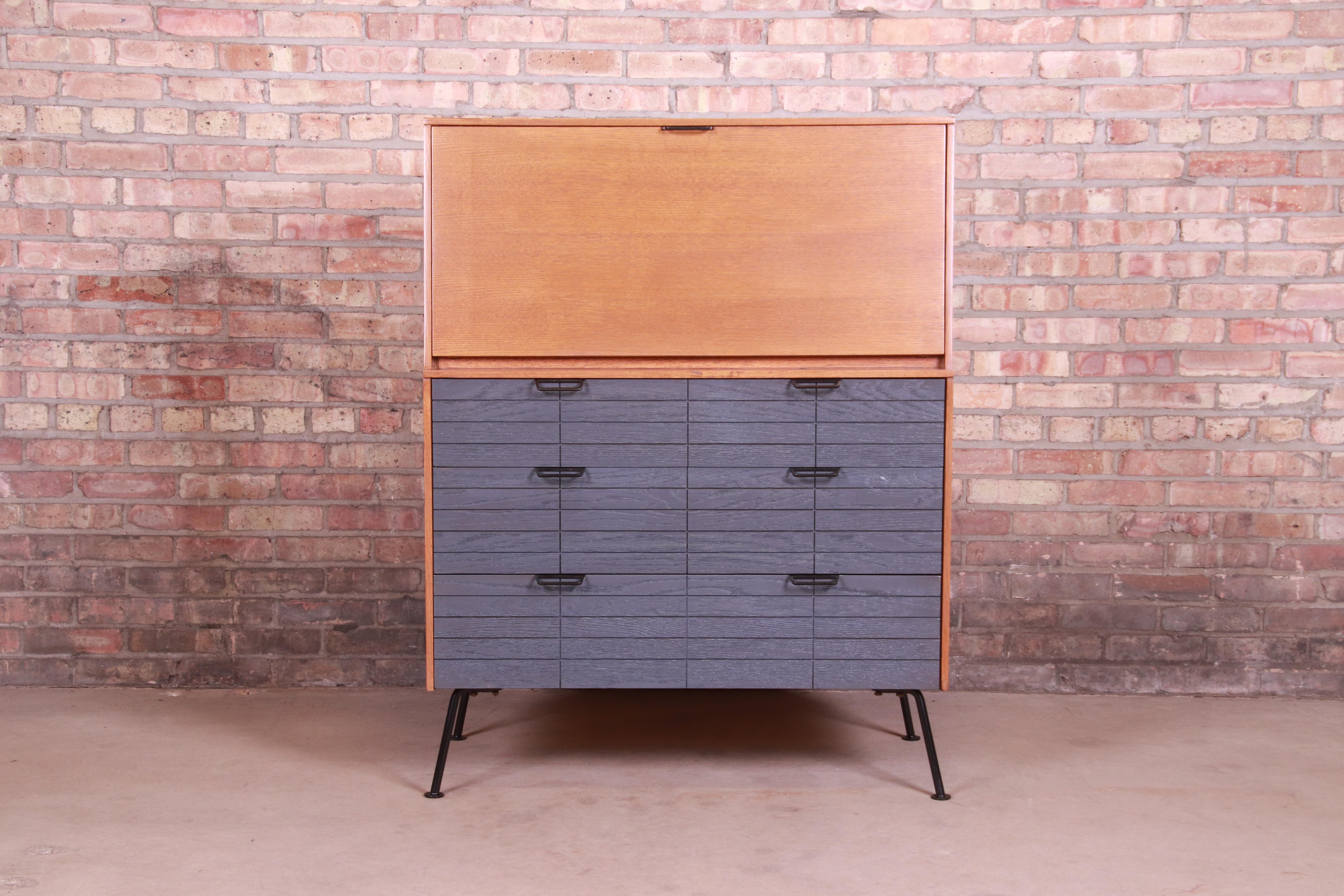 An exceptional Mid-Century Modern drop front secretary desk

By Raymond Loewy for Mengel Furniture Co.

USA, 1950s

Combed oak, with cerused oak drawer fronts and original iron legs and hardware.

Measures: 36.25