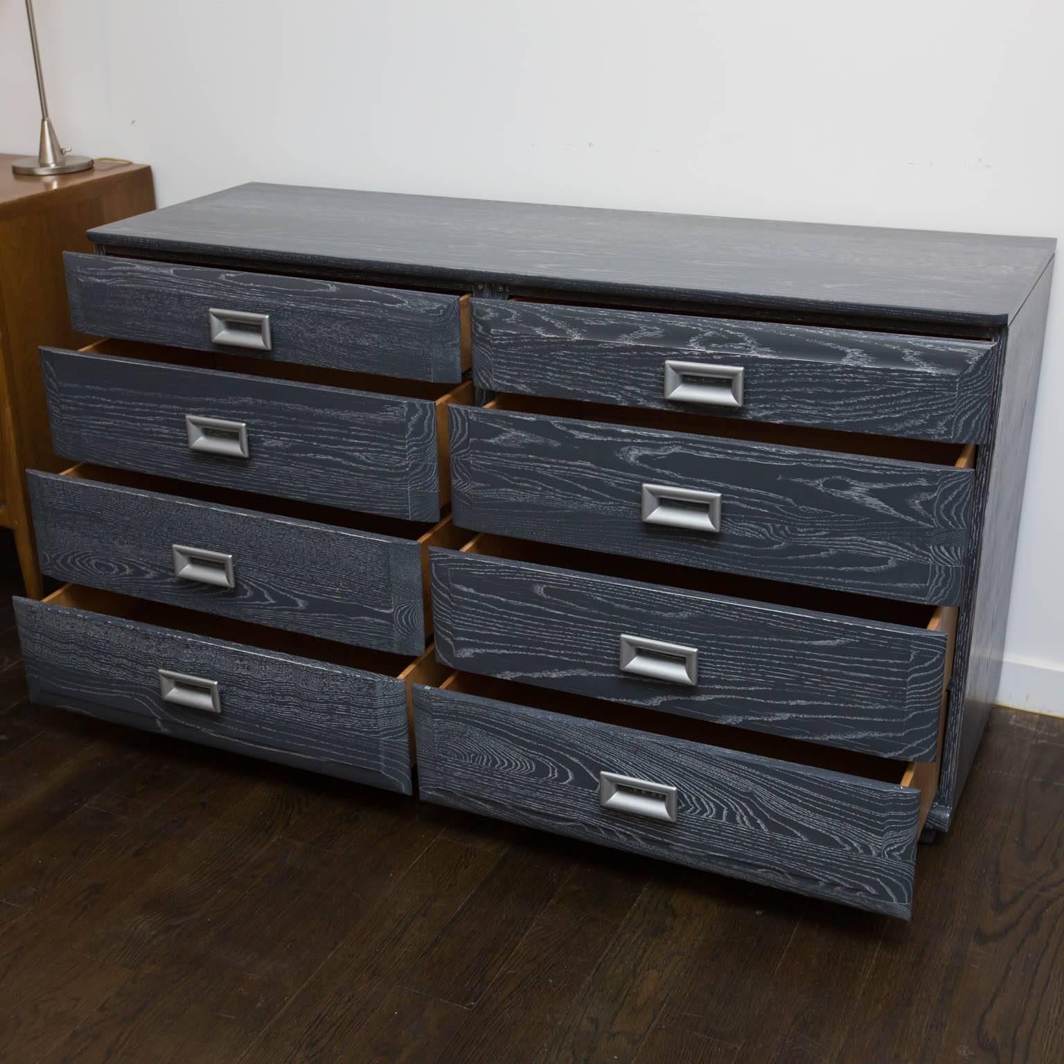 Newly refinished in a dark grey ceruse over a solid oak frame with lacquered silver drawer pulls.