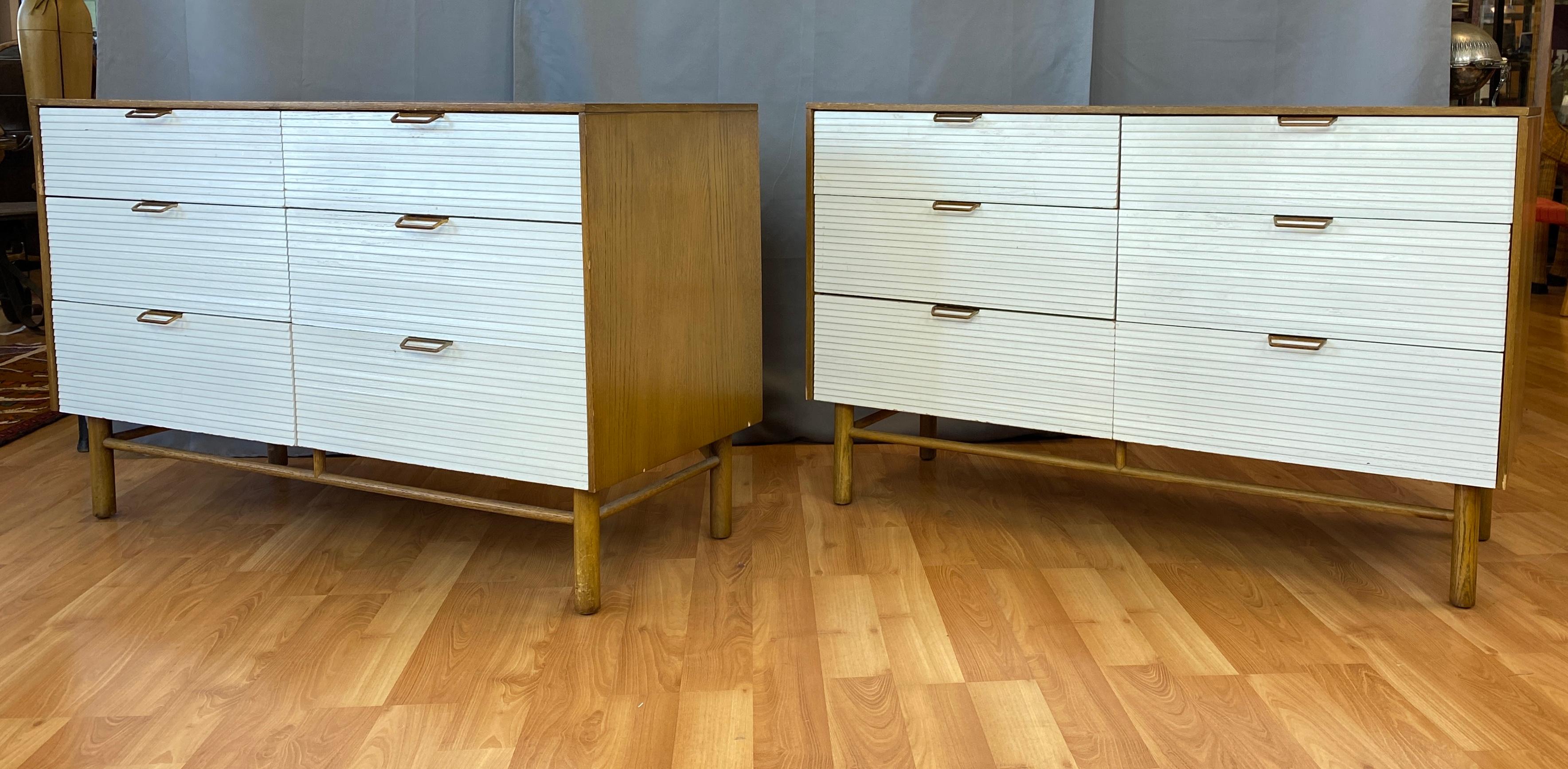 Raymond Loewy designed six drawer dresser for Mengel Furniture. We had two available in this listing, now just one.

Two tone bodies are light Brown painted oak with White louvered drawer fronts, handles are stamped steel with Brass coloring. 
Both
