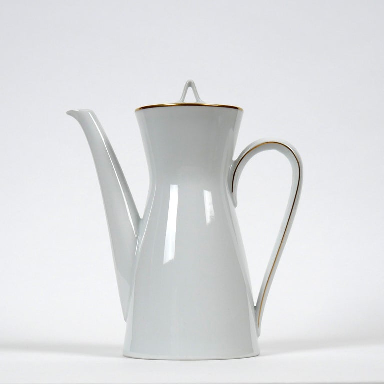 Raymond Loewy and Richard Latham for Rosenthal, 1954
‘Form 2000’ Coffee Pot

A lovely example of this design classic
White ceramic with gold edging
Excellent condition, appears to be unused
Makers stamp to underside

Dimensions approx.: