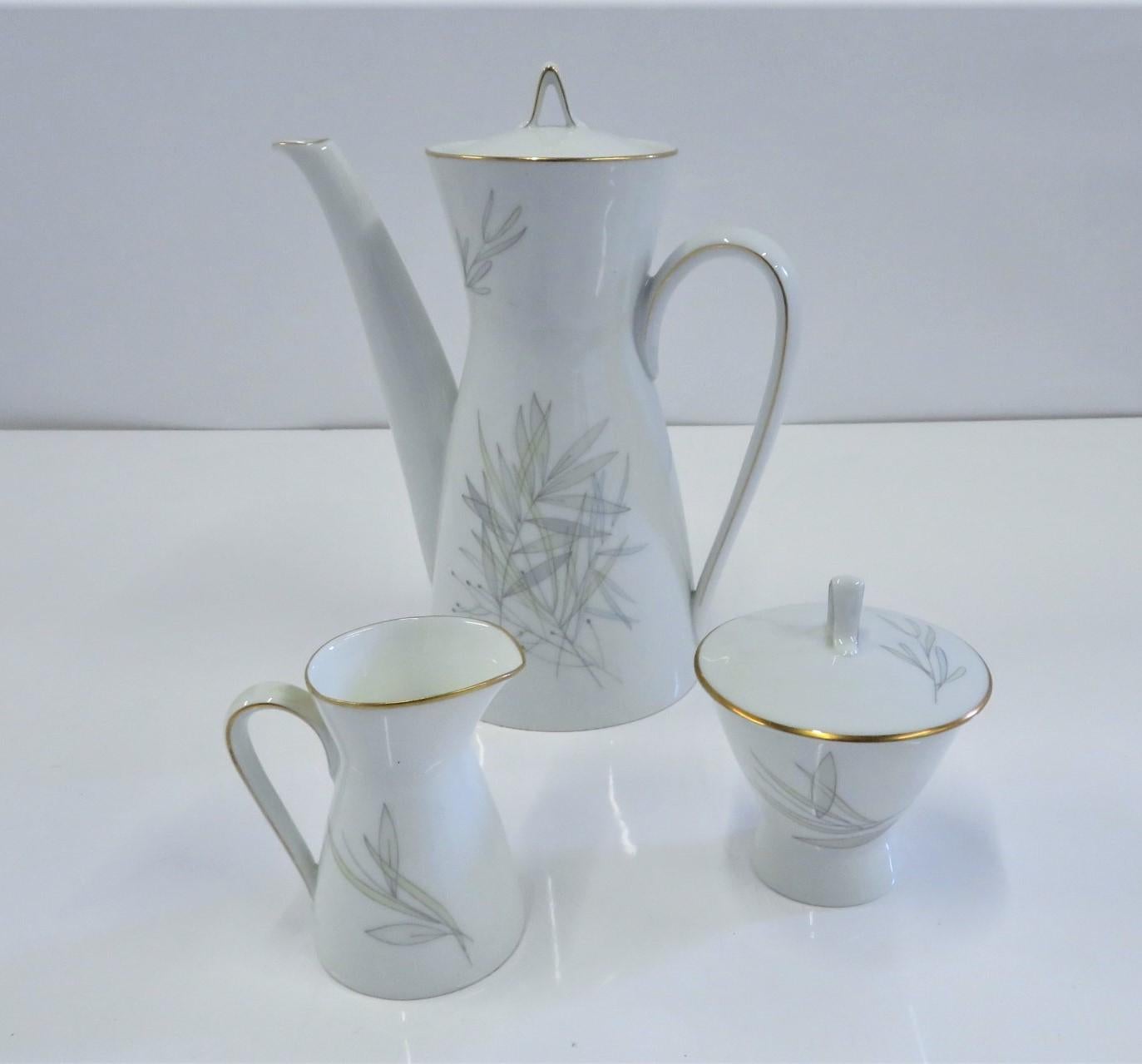 A Mid-Century Modern porcelain coffee service set consisting of coffee pot, creamer and lidded sugar by Rosenthal in the GRASSES pattern with the iconic “2000” form designed by Raymond Loewy in the 1950s. This lovely pattern is decorated with gray,