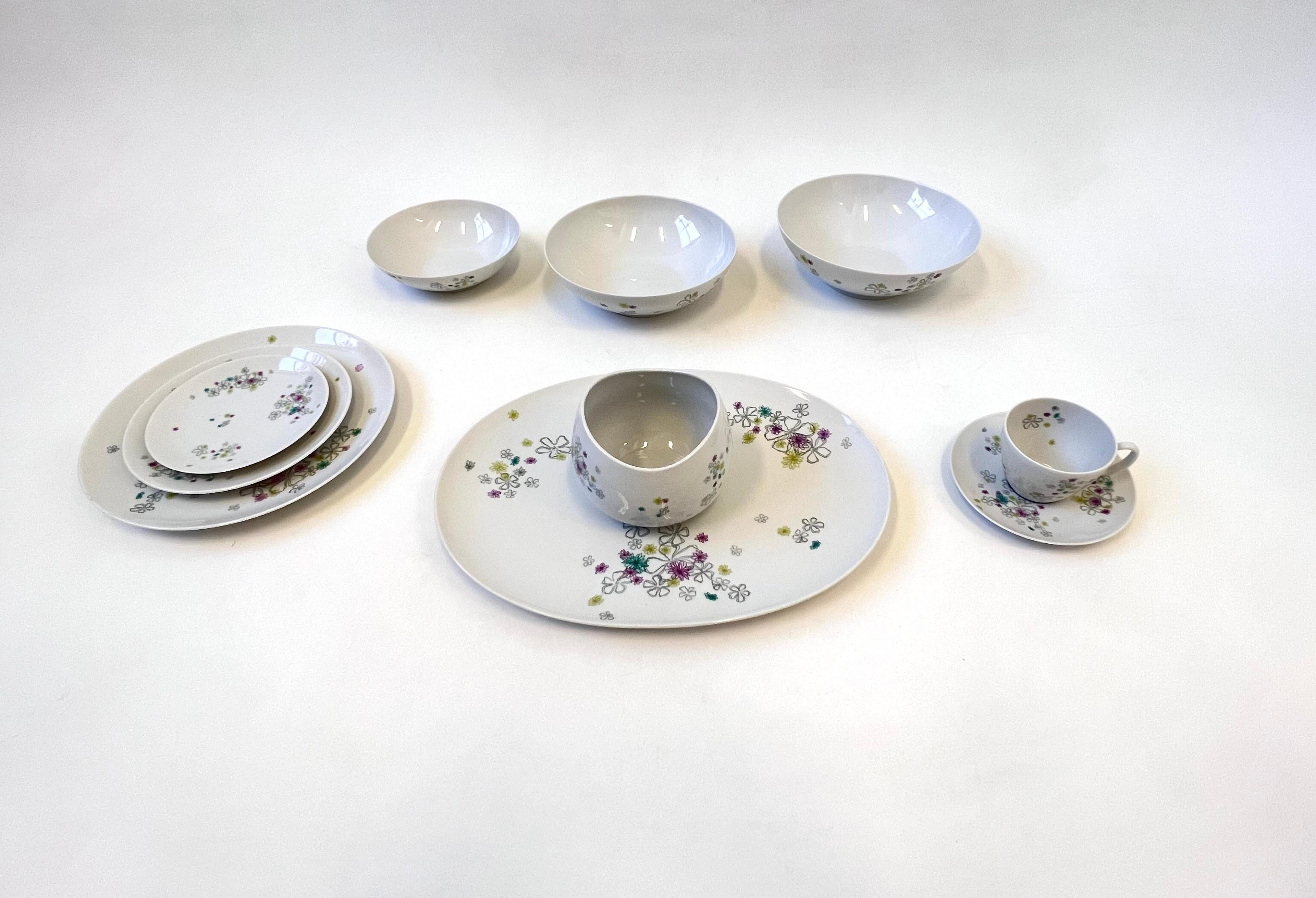German porcelain china dinnerware service for 12 by renowned American designer Raymond Loewy. 
The set consists of 12 dinner plate, 12 Salad plate, 12 Desert plate, 12 Cup and saucer. 
One serving plater, three serving bowls and one gravy bowl. 