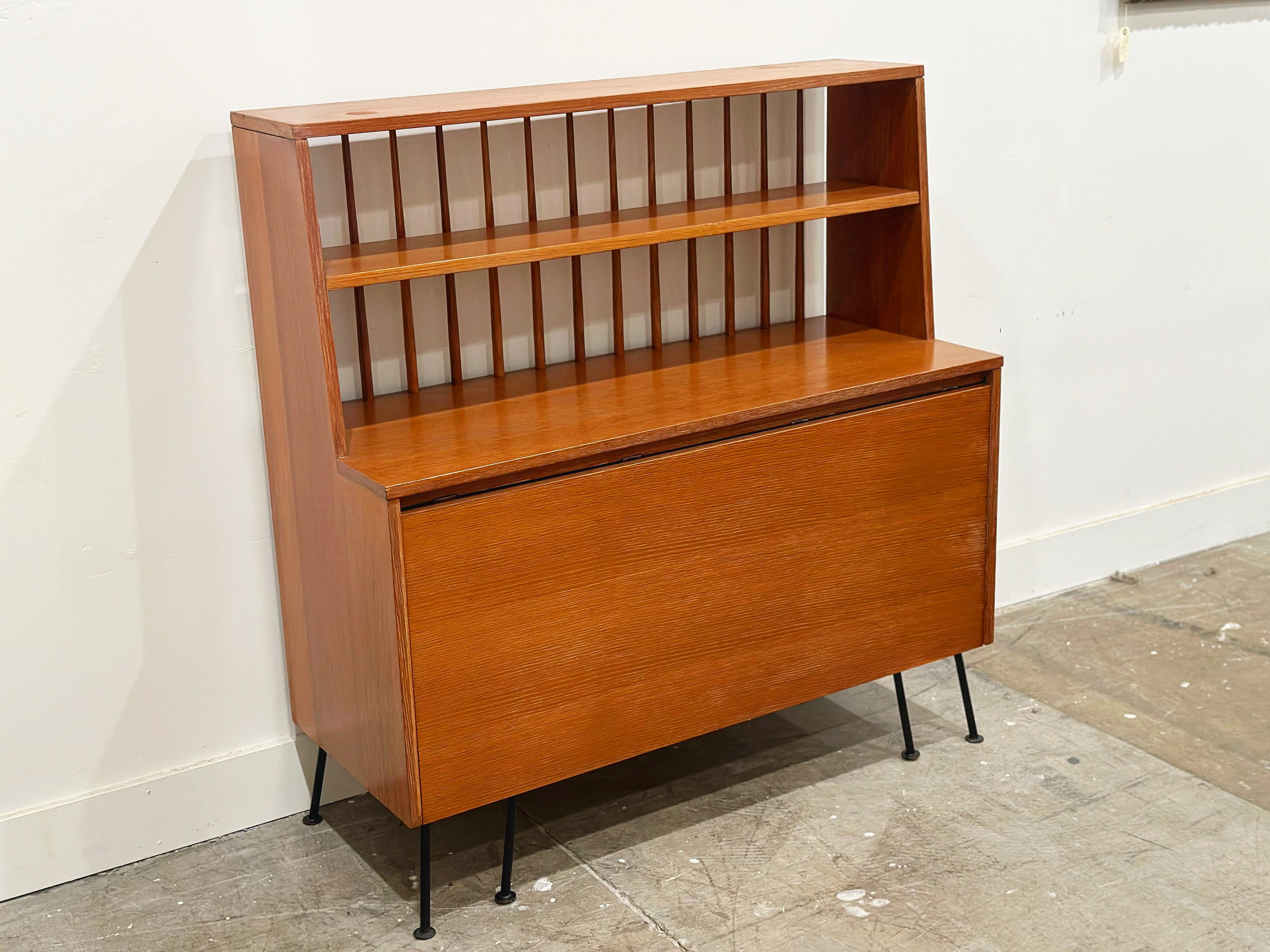 Versatile mid century modern buffet - desk - dining table by Raymond Loewy. This piece does it all! Great display area with lower storage. Leaf pulls up to work as a desk, and pulls out more to work as a dining table. Produced by Mengel Furniture in
