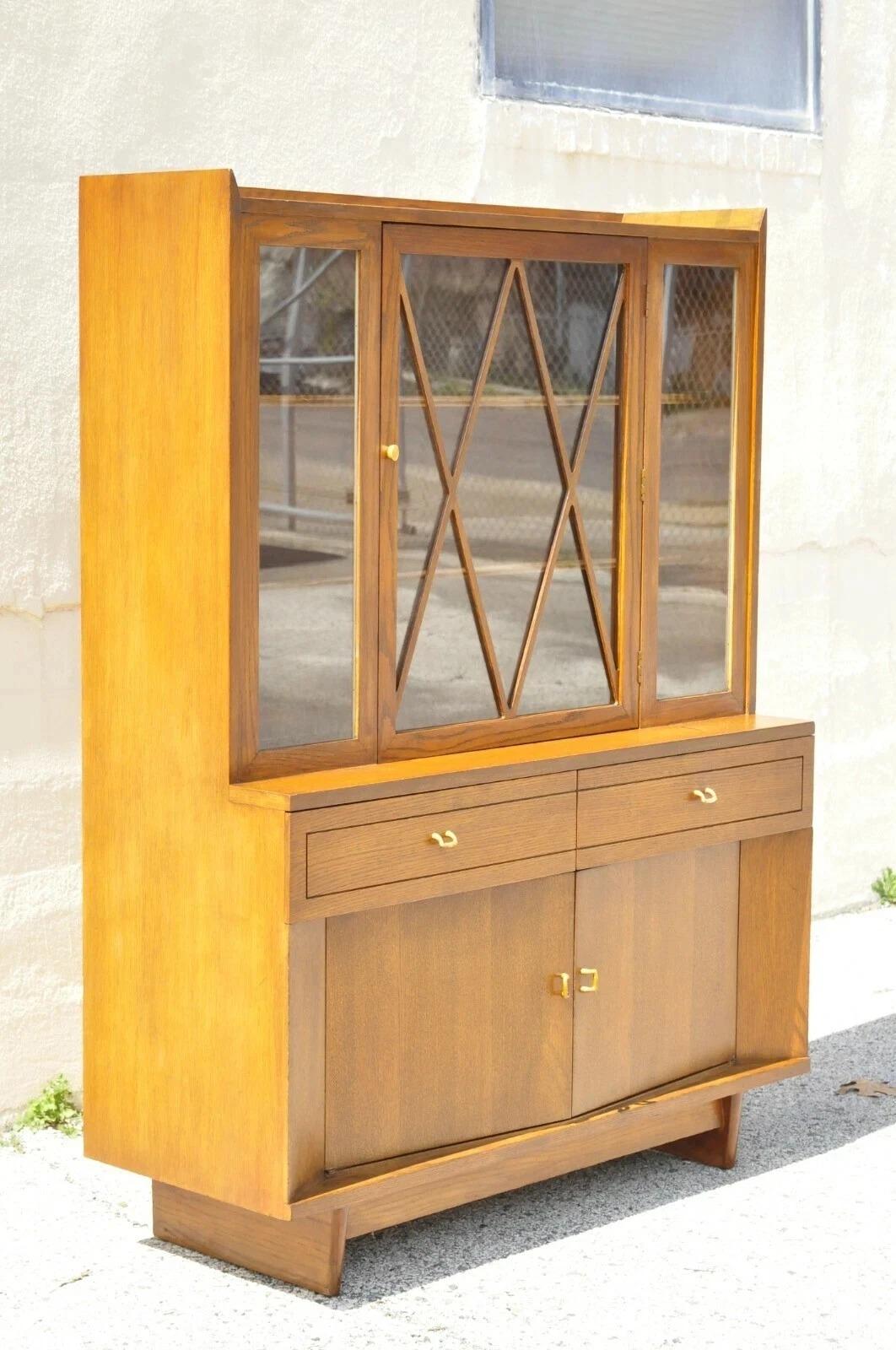 Please message us with your zip code to request a more reasonable domestic U.S. shipping quote.

Vintage Raymond Loewy for Mengel Mid Century Modern Sculpted Oak China Cabinet. Item features beautiful wood grain, 3 swing doors, 2 drawers, sleek