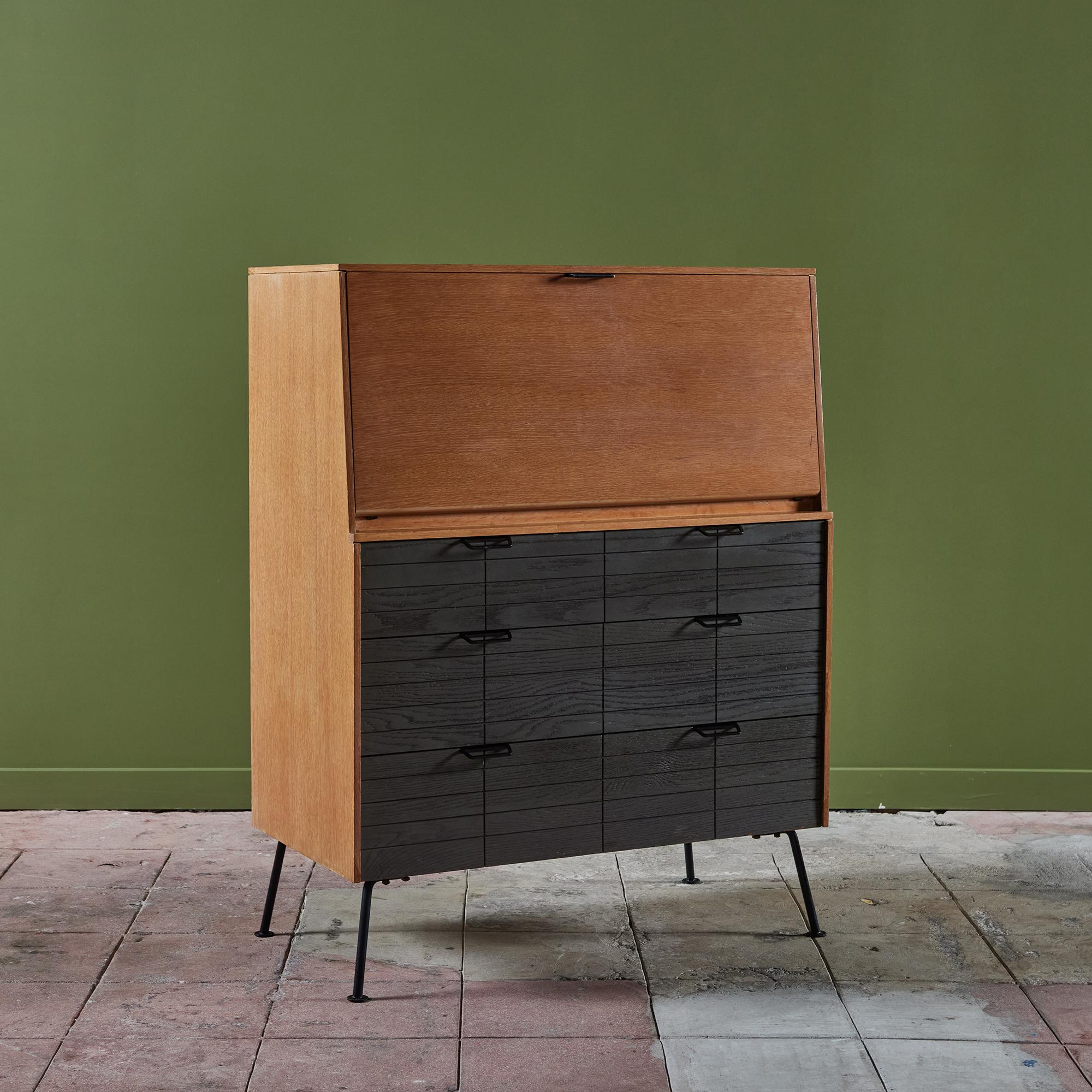Oak secretary desk by Raymond Loewy for Mengel Furniture c.1950s, USA. This drop front oak desk features three cerused front oak drawers. The interior of the desk has drawers and shelves for storage and office accessories. The piece rests on four