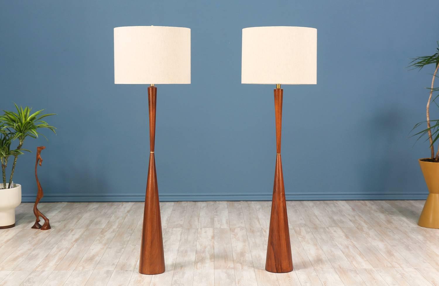 $1,295 each

Walnut floor lamps designed by Raymond Pfennig for Zina Lamp Co. in Northern California, circa 1960s. These beautiful lamps feature wood turned solid walnut bases that have been expertly refinished and a brass knuckle accent between