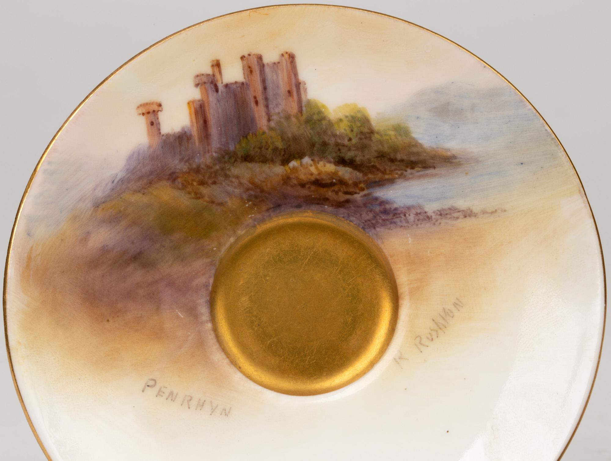 An exceptional Royal Worcester gilded demi tasse cabinet cup and saucer painted with Welsh castles by renowned artist Raymond Rushton and dating 1926-1928. This finely made porcelain set comprises of a rounded saucer with a central foot well