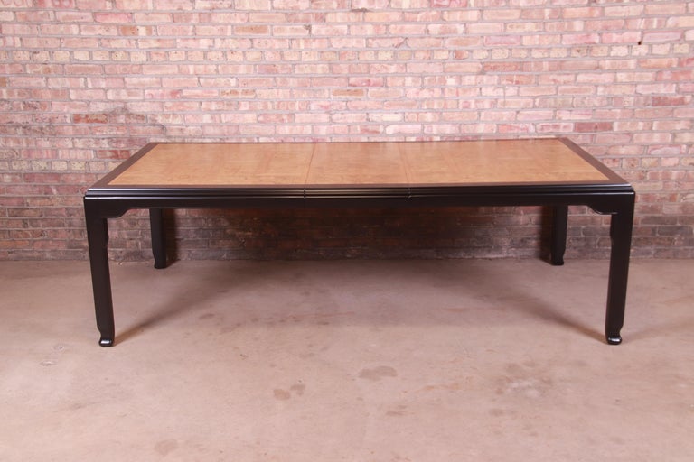 An exceptional Mid-Century Modern Hollywood Regency Chinoiserie extension dining table

By Raymond K. Sobota for century Furniture

USA, 1970s

Gorgeous inlaid burled olive wood top, with black lacquered trim and legs and subtle Asian