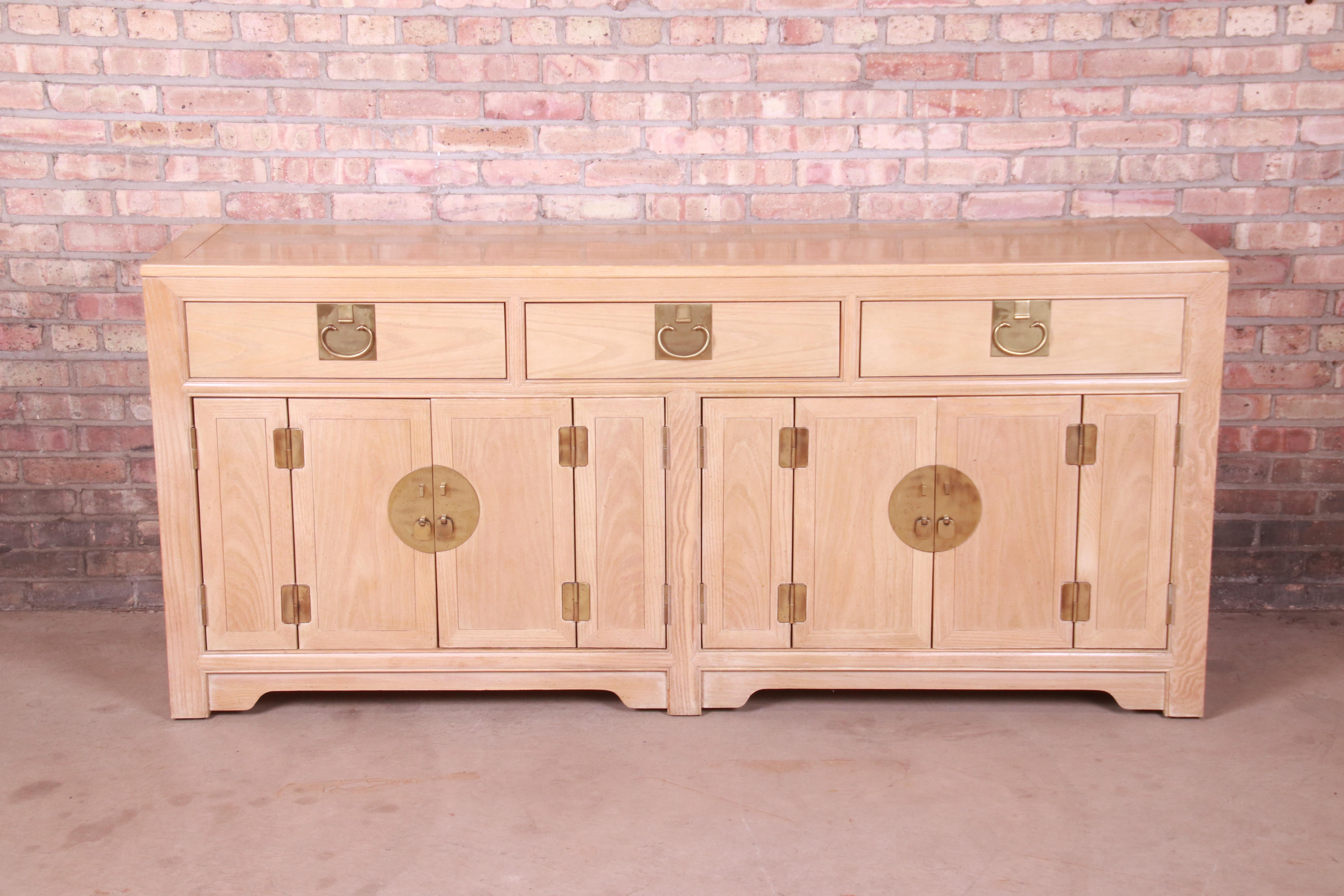 A gorgeous mid-century modern Hollywood Regency Chinoiserie sideboard, credenza, or bar cabinet

By Raymond K. Sobota for Century Furniture

USA, circa 1970s

Bleached walnut, with original Asian-inspired brass hardware.

Measures: 74.75