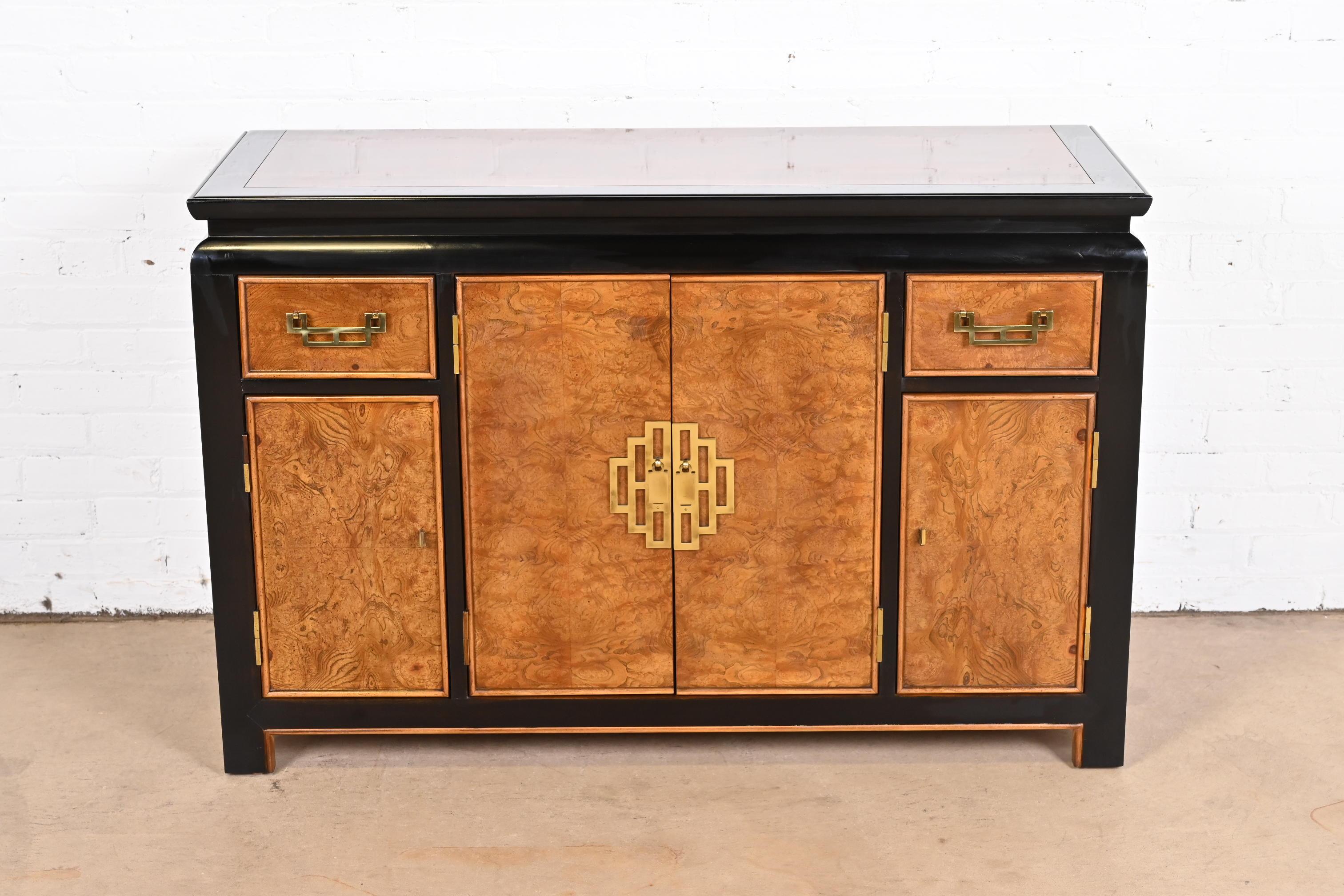 An exceptional mid-century modern Hollywood Regency Chinoiserie sideboard, credenza, or bar cabinet

By Raymond Sobota for Century Furniture

USA, 1970s

Burl wood, with ebonized trim, and original Asian-inspired brass hardware.

Measures: