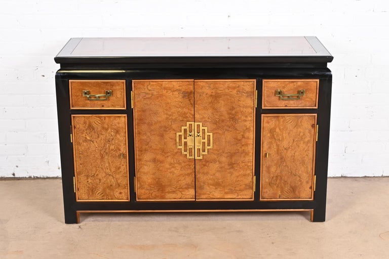 An exceptional mid-century modern Hollywood Regency Chinoiserie sideboard, credenza, or bar cabinet

By Raymond Sobota for Century Furniture

USA, 1970s

Burl wood, with ebonized trim, and original Asian-inspired brass hardware.

Measures: