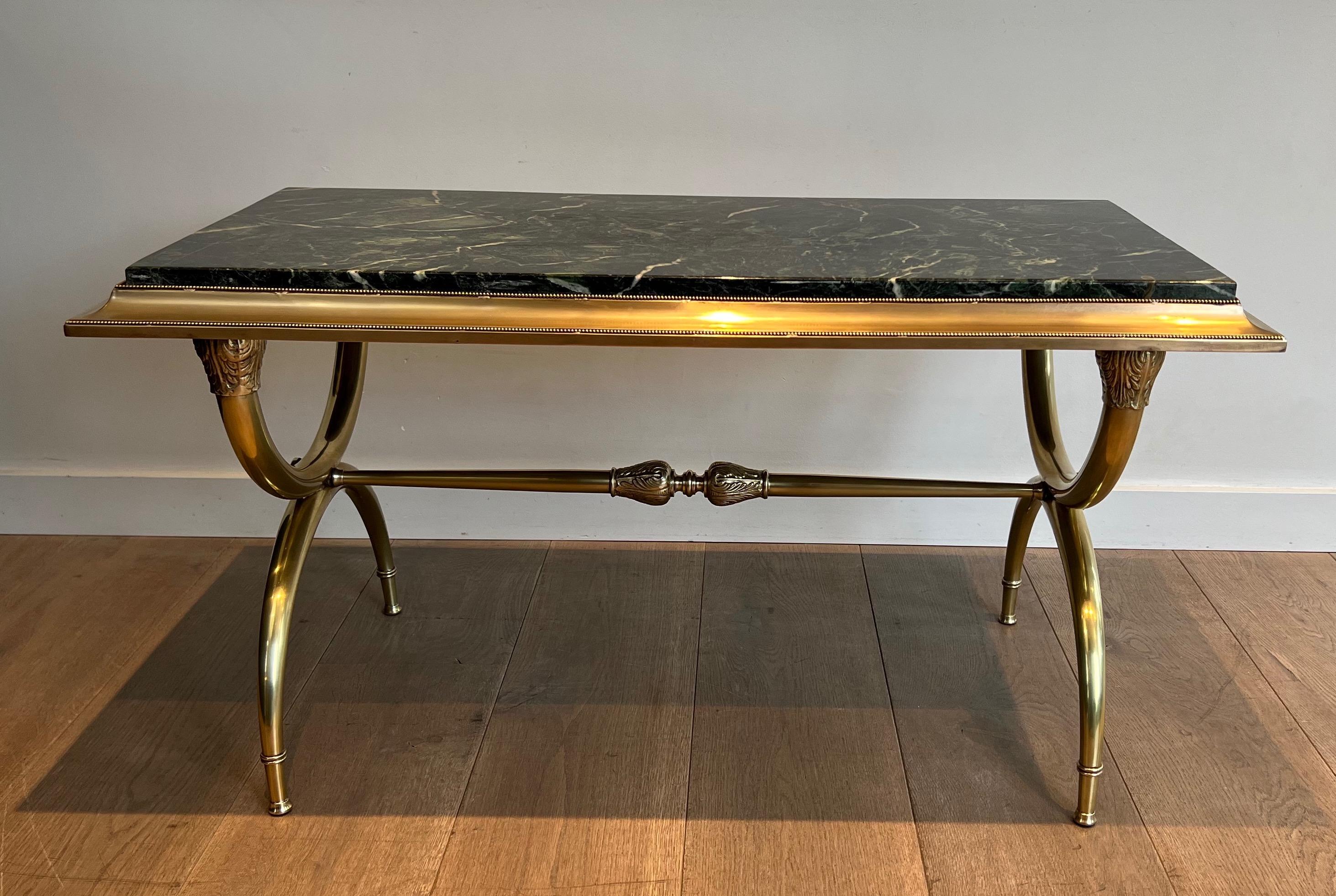 This neoclassical style coffee table is made of brass with a green marble top. This is a French work by famous designer Raymond Subes. Circa 1940