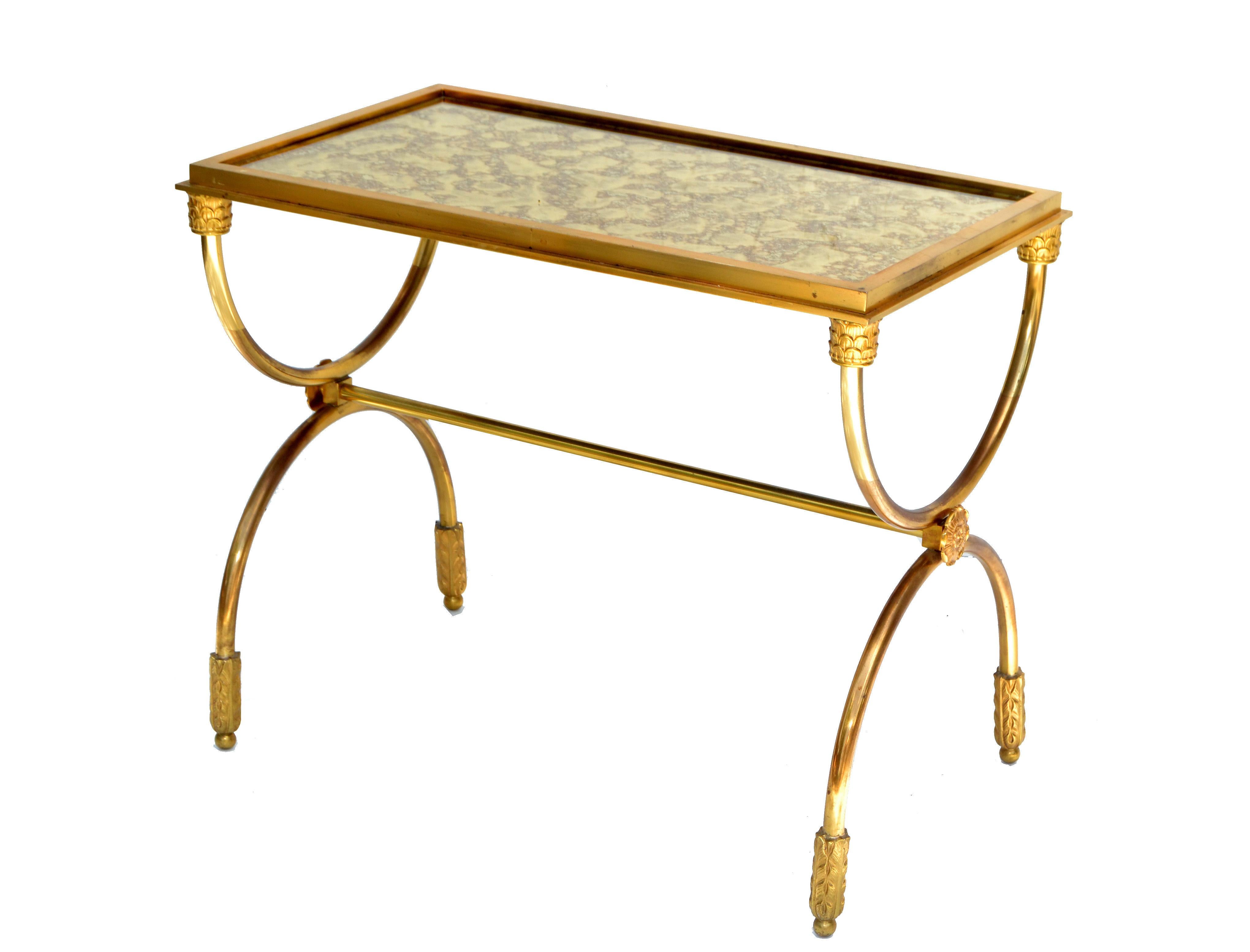Superb and rare Raymond Subes attributed side table with brass ornaments, semi circular bronze base and a mirrored glass top.
French neoclassical design in brass details and a heavy crafted bronze base.
Glass top measures: 21.75 x 11.75 inches.