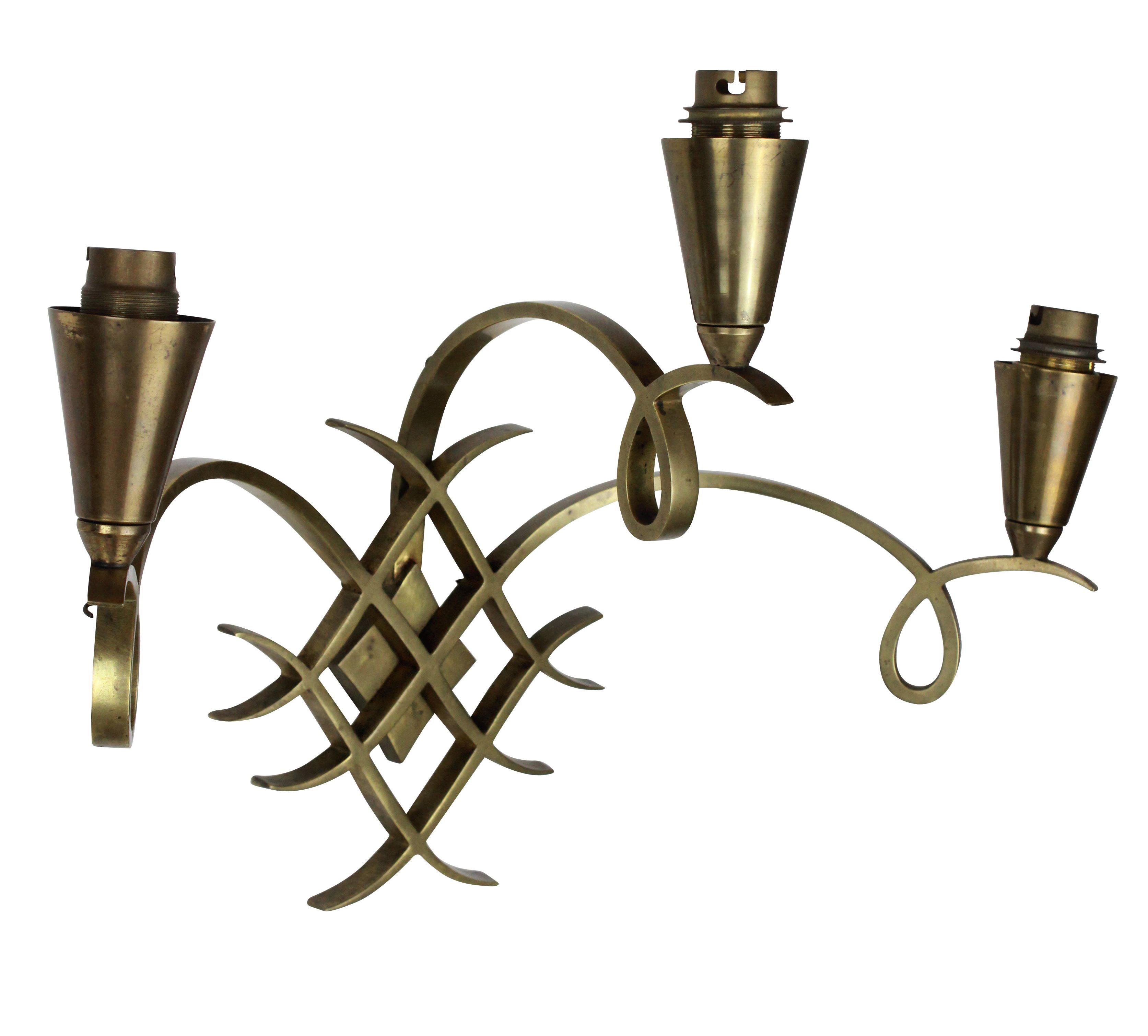 A French brass wall sconce in the manner of Raymond Subes.
    