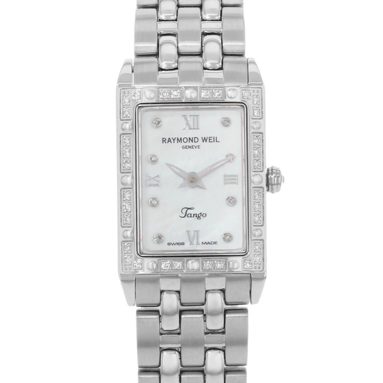 Excellent Pre-owned Condition Raymond Weil Tango 5971-STS-00995.  The watch has a rectangle shape face, diamonds dial, and hand diamonds style markers. It is completed with a stainless steel band that opens and closes with a push-button double fold