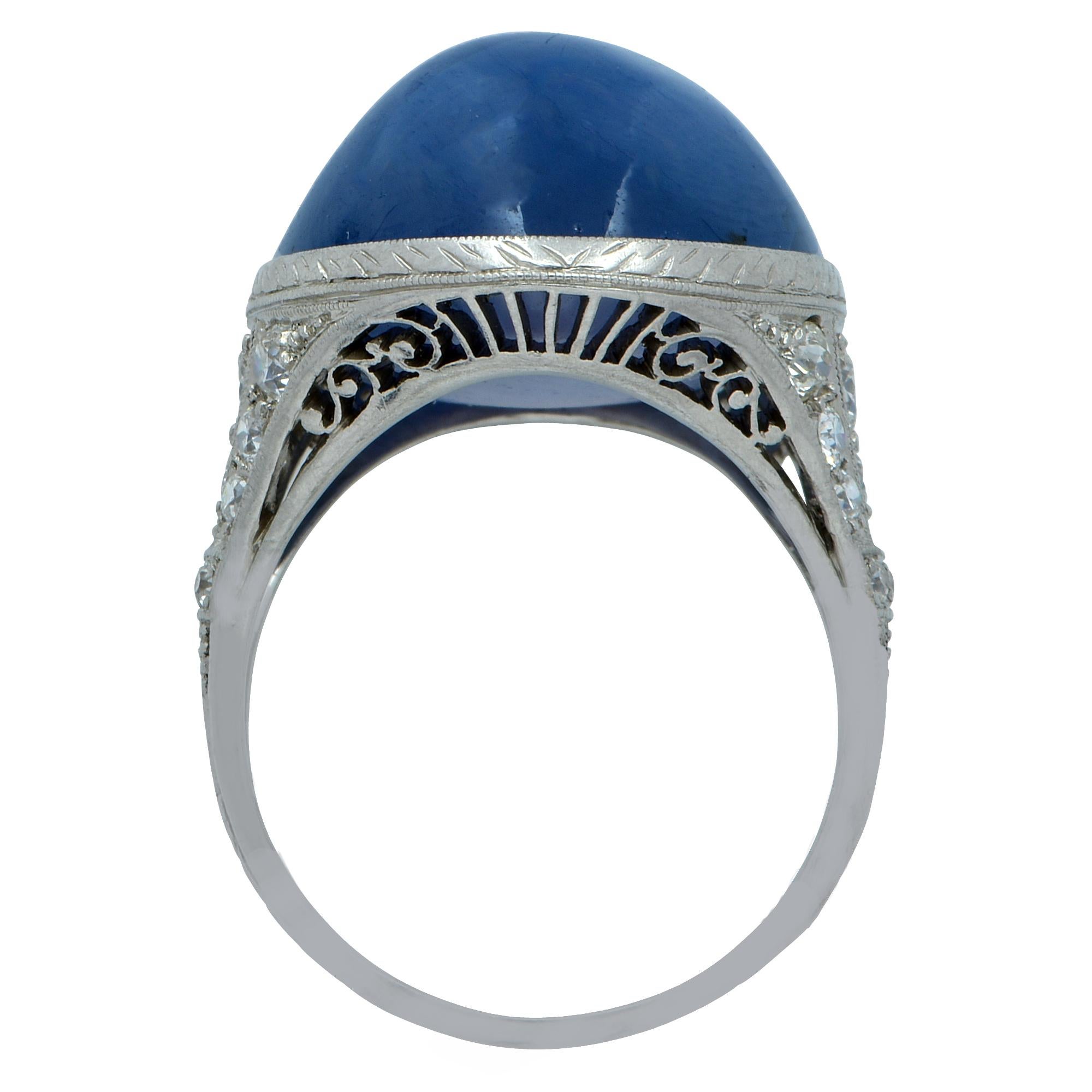 Captivating handmade platinum ring by Raymond Yard featuring an alluring 20 carat star cabochon sapphire, accented by 22 round brilliant cut diamonds weighing approximately .75 carats. This intriguing sapphire is the most magnificent blue. The stone