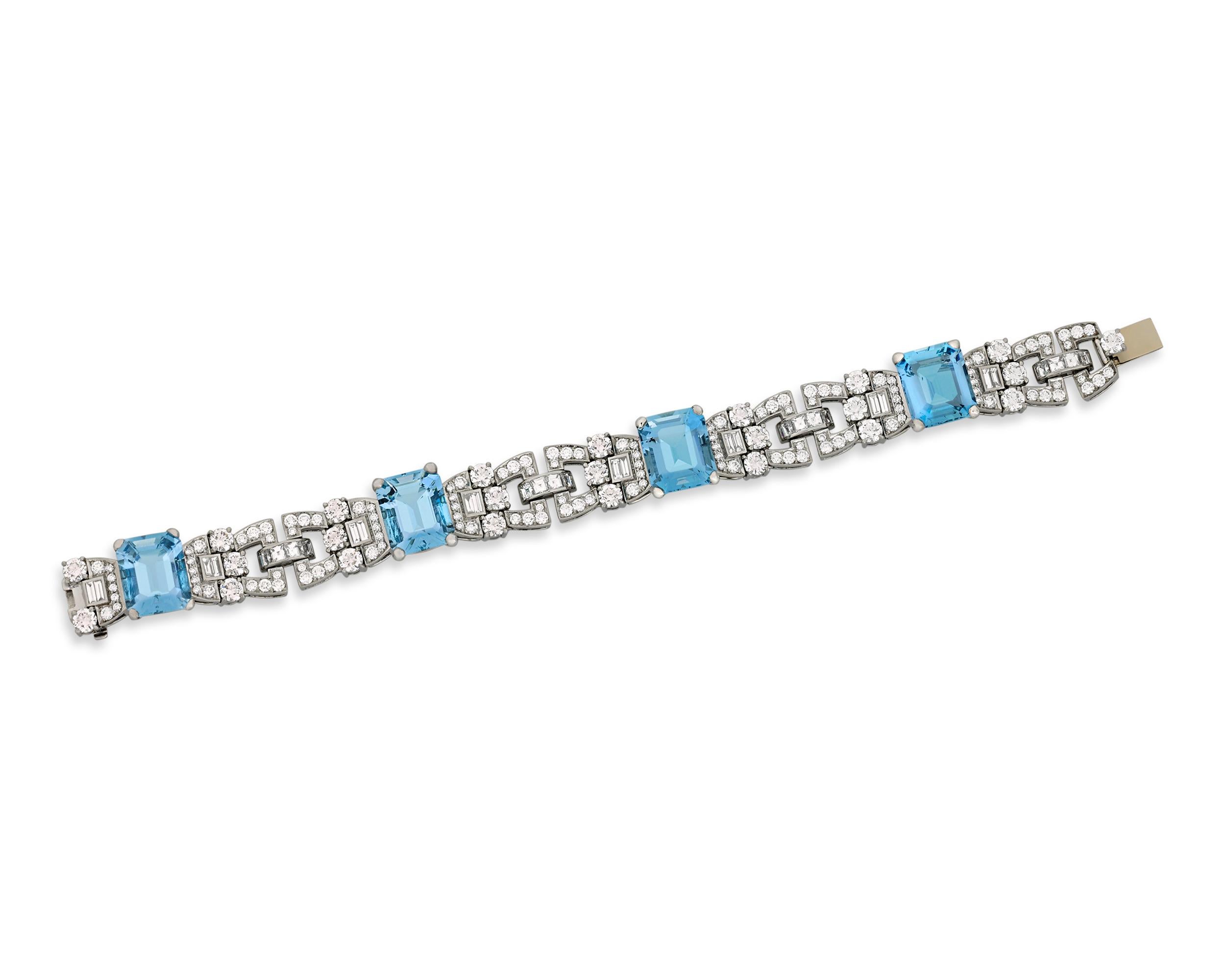 This remarkable bracelet by Raymond Yard showcases four stunning emerald-cut aquamarines totaling 25.76 carats. Displaying a stunning ocean-blue color and exceptional clarity, the elegant jewels are accentuated by a host of dazzling baguette, square