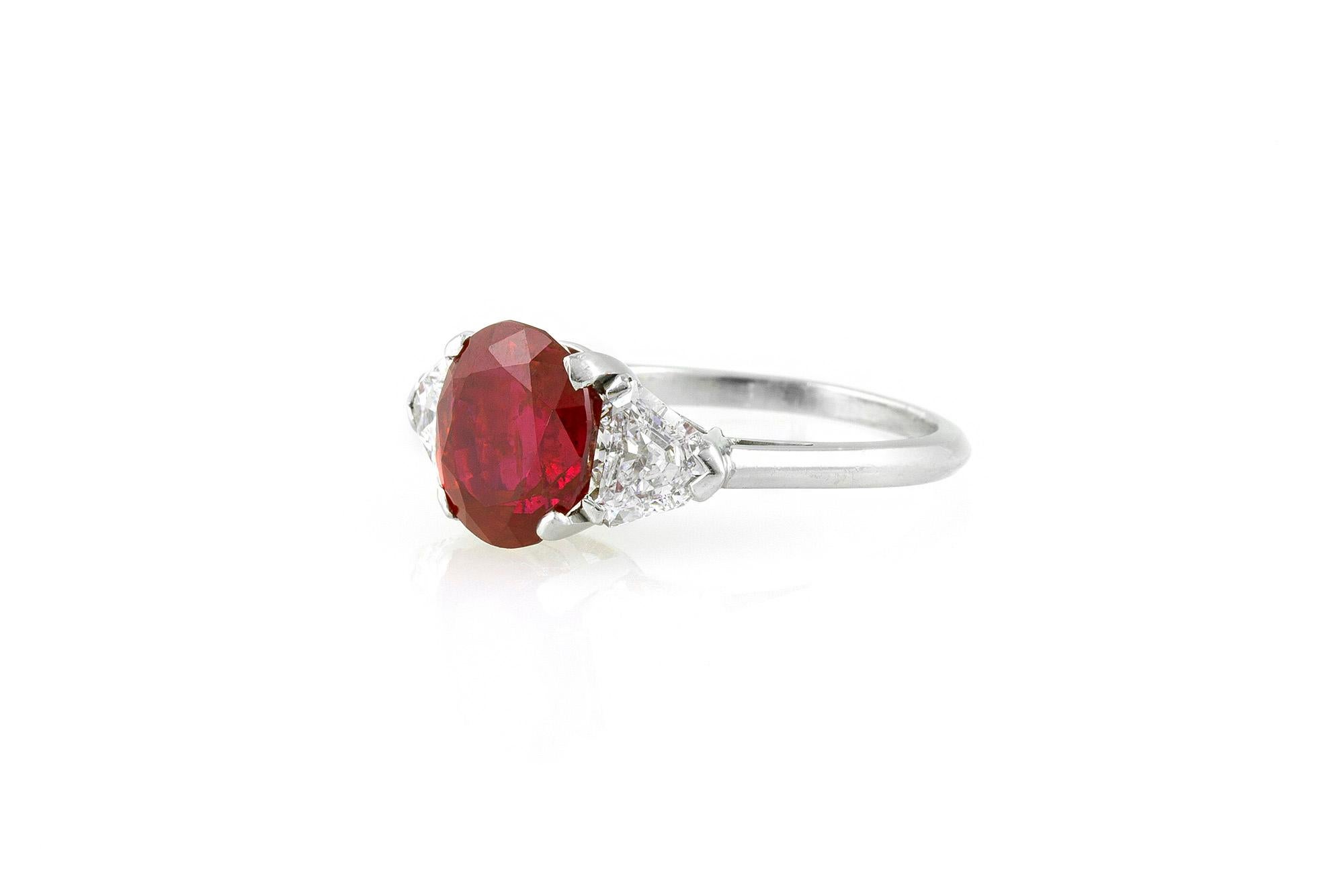 A beautiful ring, centering upon an oval-shaped ruby weighing 4.63 CT BURMA, NO HEAT. The center stone is flanked on either side by diamonds weighing 0.70 CT mounted in platinum signed R. Yard.
Accompanied by reports from AGL and GIA.