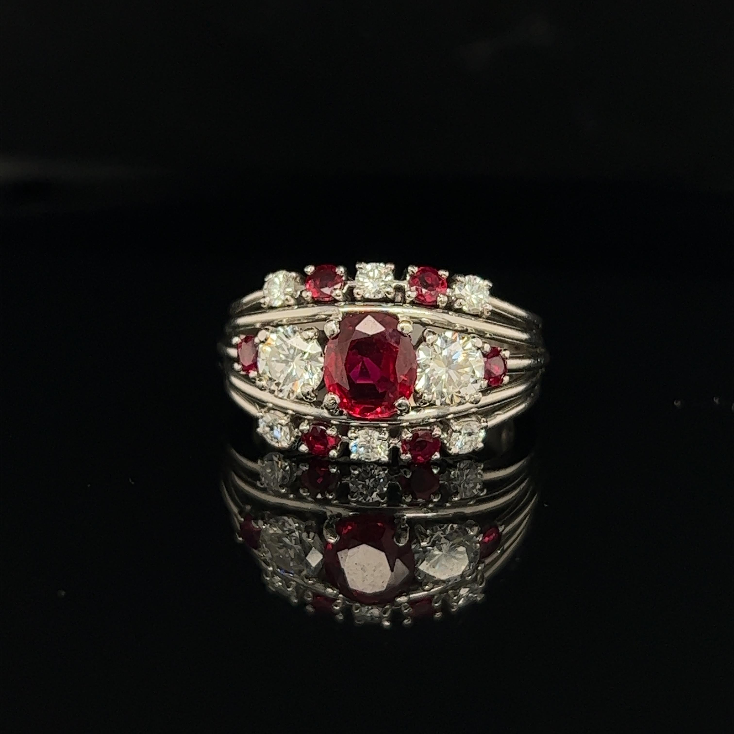Beautiful ring from famed American designer Raymond Yard. The ring is crafted in platinum and highlights ruby and diamond gemstones. The center gemstone is one Burma no heat ruby  gemstone. Burmese rubies are distinguished by their pure red color