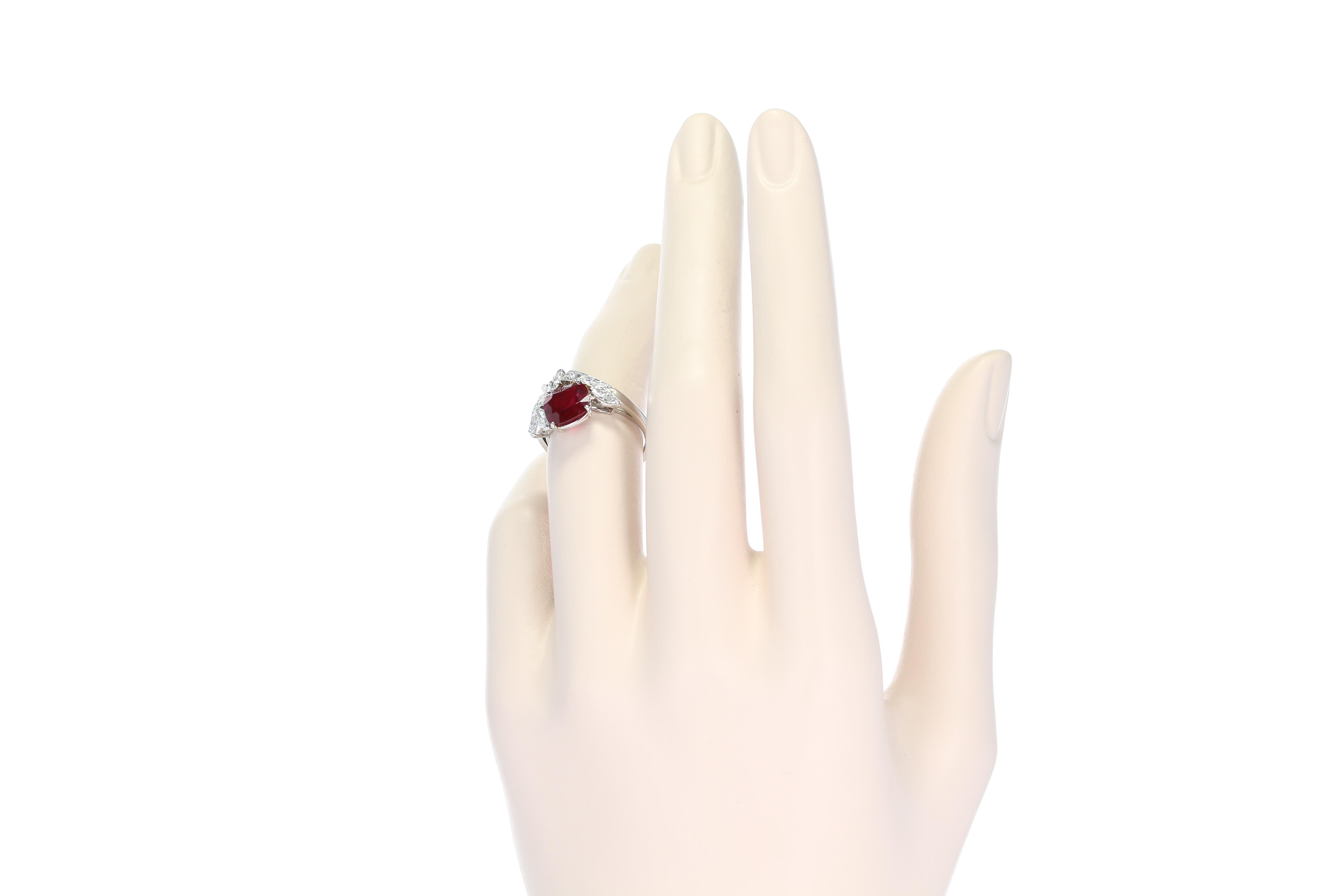 A cushion cut vivid red burmese (no heat) ruby weighing 3.01 carat accented with round briliant and marquise diamond spray set in Platinum. The ruby accompanies a gemological report from AGL stating country-of-origin as Burma (Myanmar) with No Heat